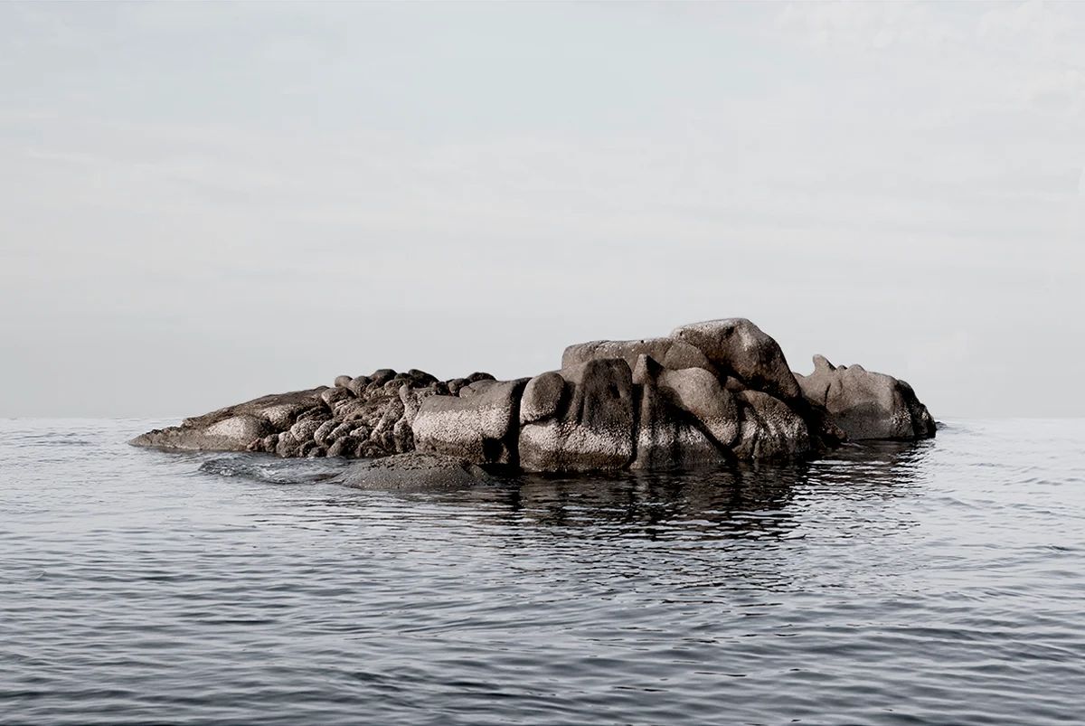 Island Hoping by Christina Dimitriadis — A granite rock formation rises from calm Mediterranean waters in this centered landscape composition.