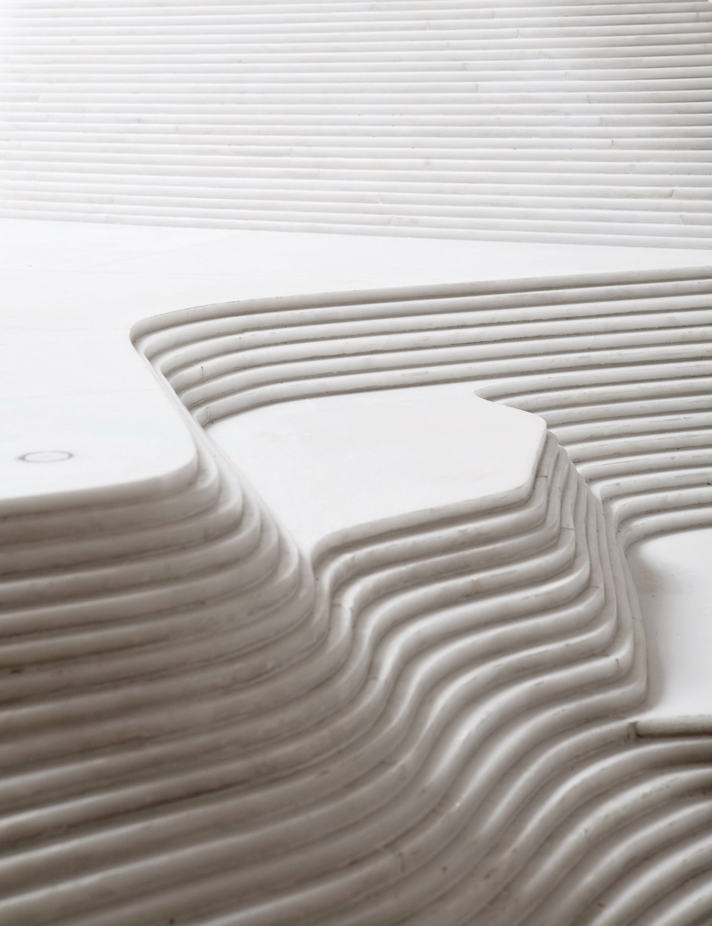 St Hilaire Church in Melle by Mathieu Lehanneur — Close-up detail of stacked white marble forming the liturgical furniture intervention.