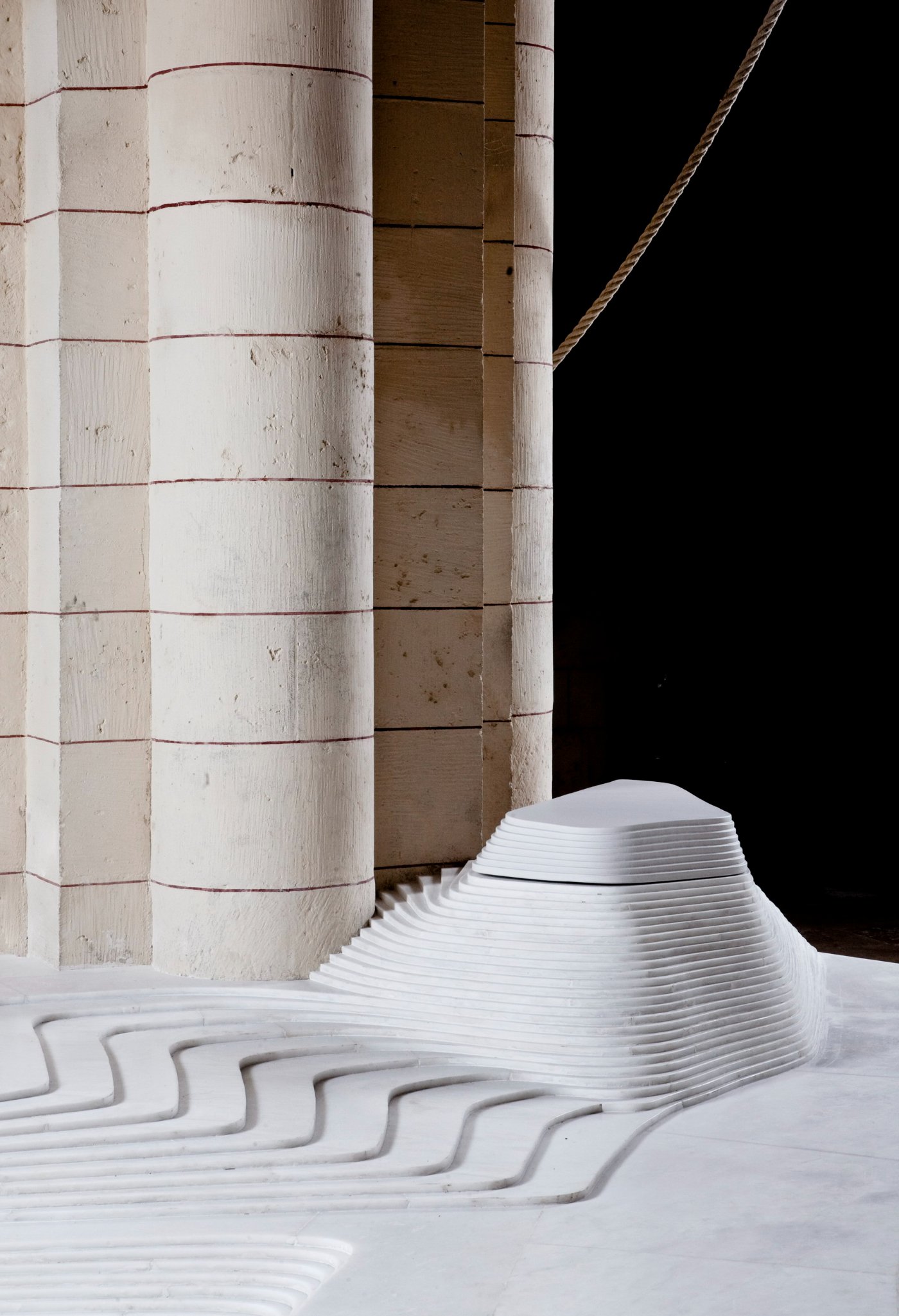 St Hilaire Church in Melle by Mathieu Lehanneur — A close-up perspective of Lehanneur's marble intervention within the Romanesque church, isolating the baptistery form from its architectural context.