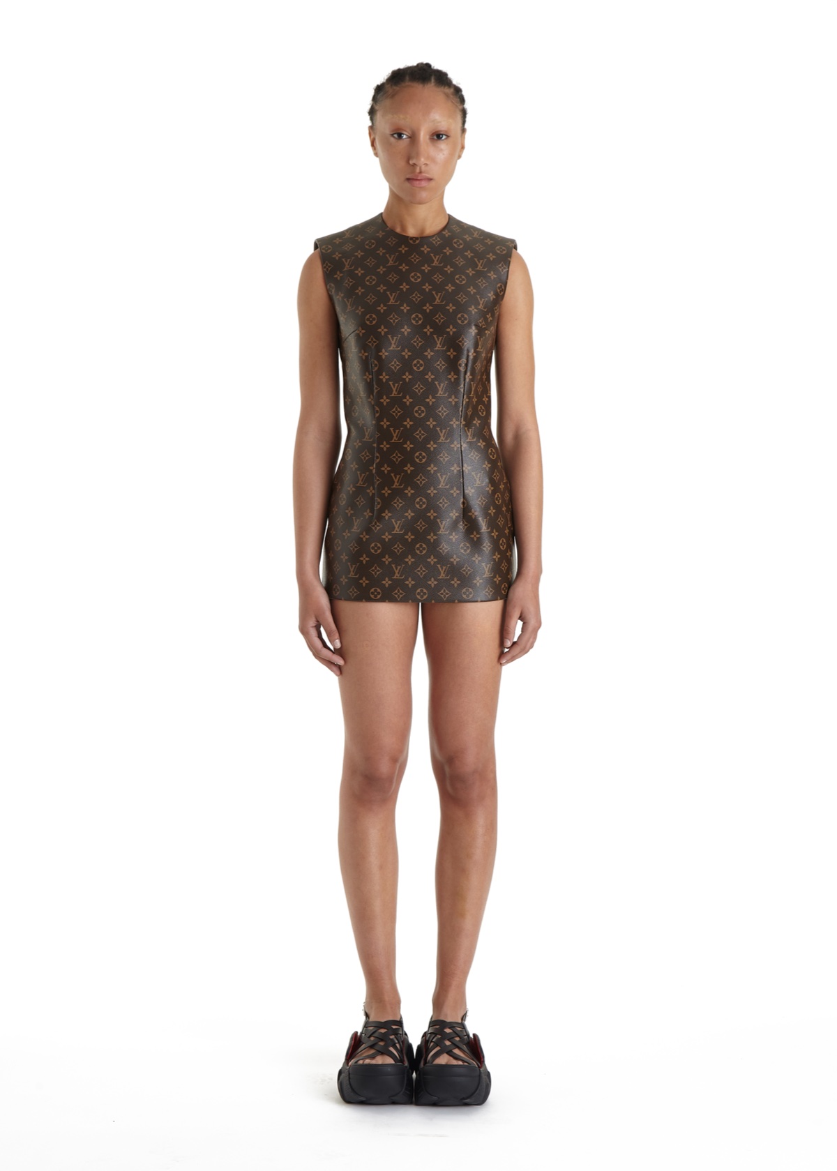 SSAW22 by Duran Lantink — A monochromatic sleeveless dress in brown monogram-patterned fabric serves as the architectural centerpiece of this presentation.