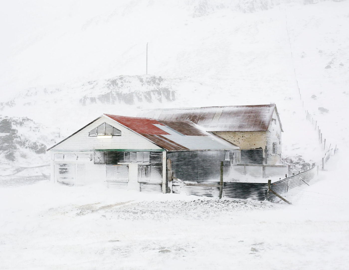 The Weather Report by Marzena Skubatz — A weathered domestic structure at Marsibil weather station sits anchored against Iceland's harsh landscape.