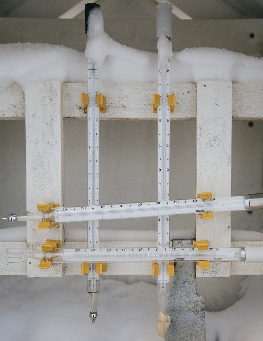 The Weather Report by Marzena Skubatz — Precision measurement instruments dominate this close-up documentation of weather station equipment mounted on whitewashed concrete structural elements.