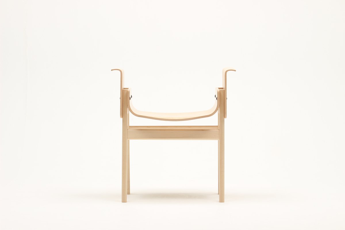 SAND by Koichi Futatsumata Studio — SAND chair photographed front-on against a neutral background, revealing its backless, bidirectional design.