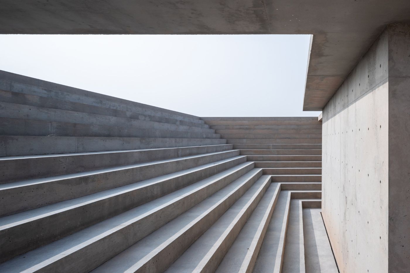 McNeal 020 Pavilion by Atelier David Telerman — A low-angle photograph capturing the McNeal 020 Pavilion's monolithic concrete staircase descending into the Arizona landscape.