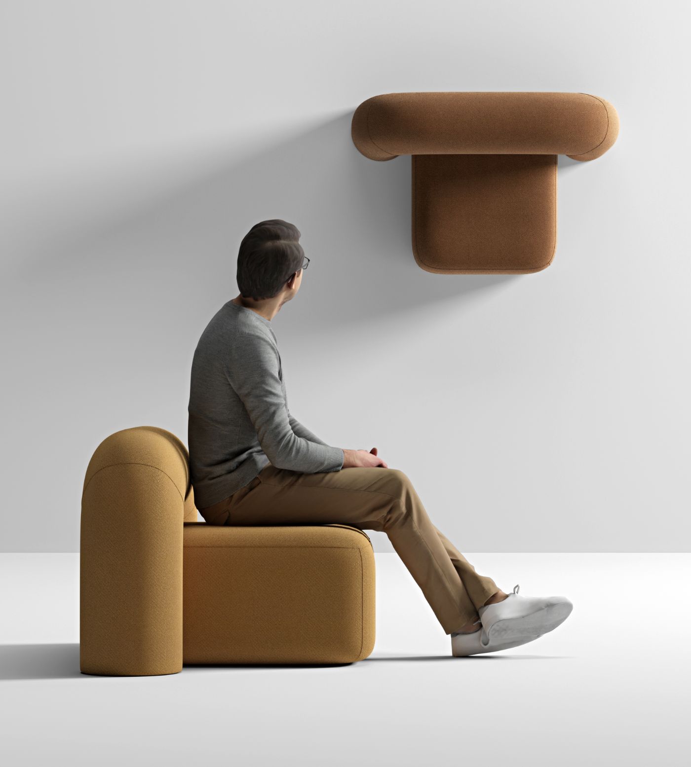 Moss Sofa collection by Pavel Vetrov Studio — A man in glasses and neutral tones sits on a volumetric rounded armchair upholstered in caramel-toned bouclé fabric.