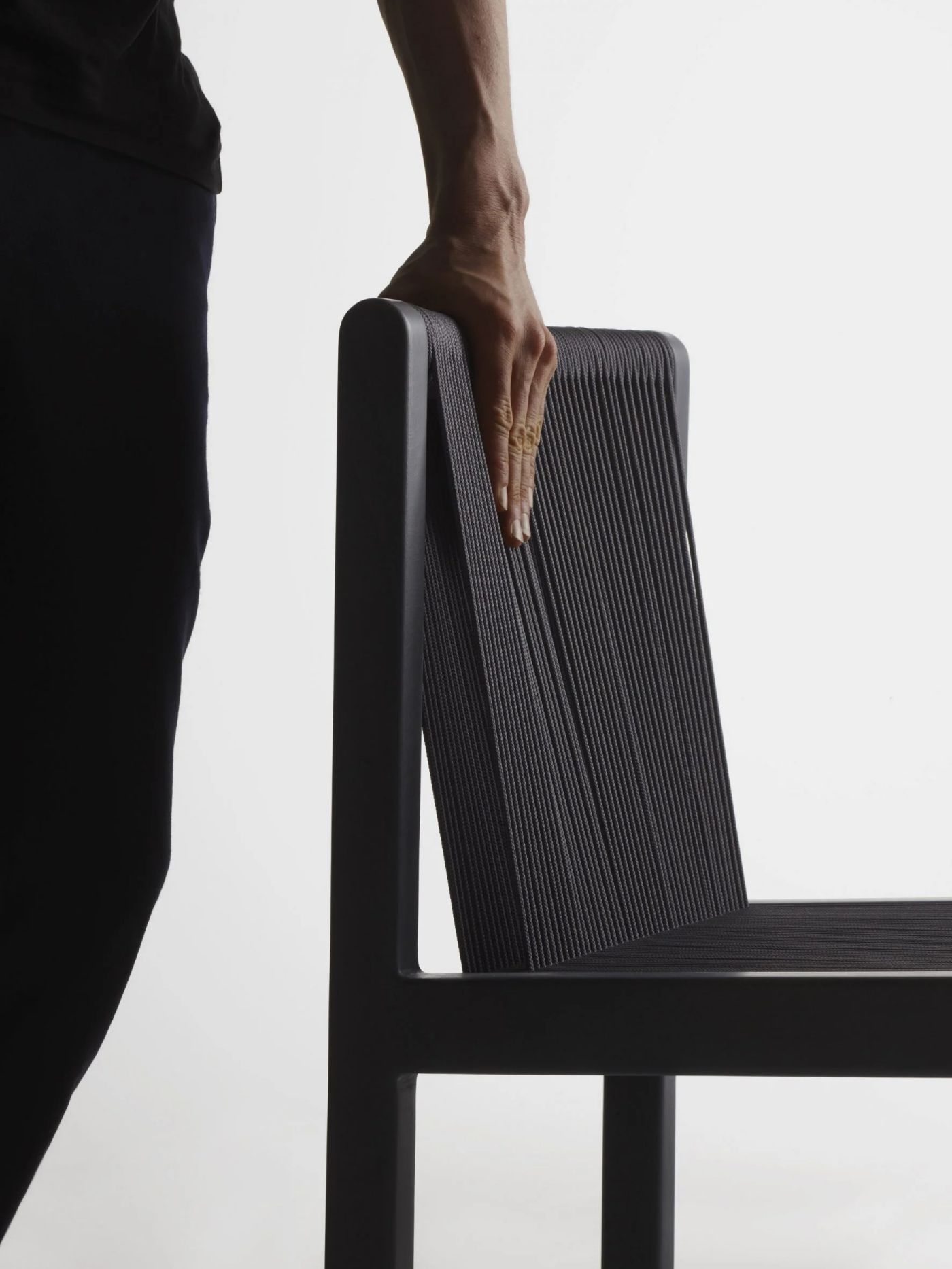 FILO CHAIR by Ronan & Erwan Bouroullec for Mattiazzi by Ronan and Erwan Bouroullec — A close-up detail photograph of the Filo chair's backrest captured from a low angle against a neutral backdrop.