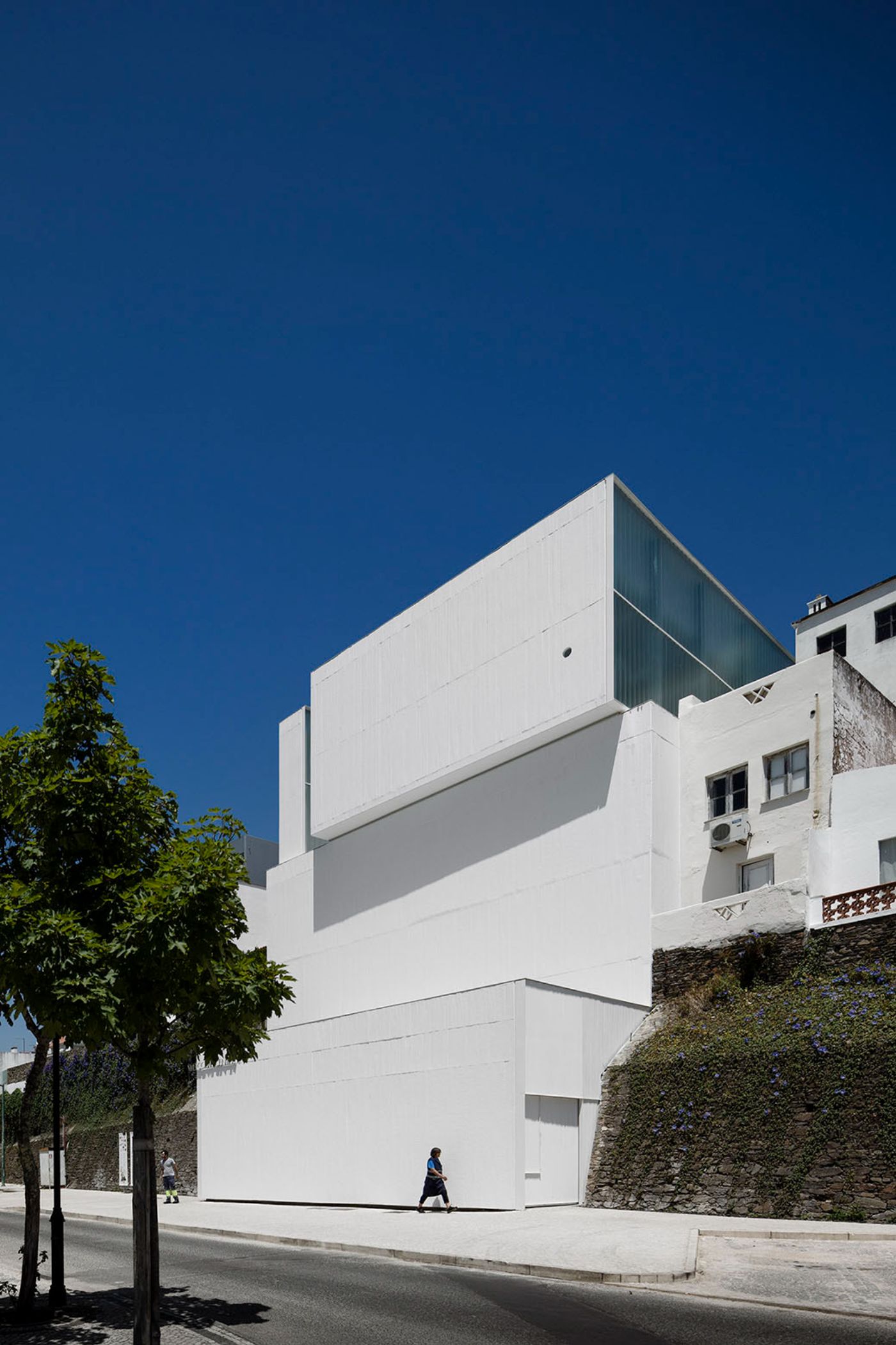 Abrantes Municipal Market by ARX Portugal — ARX Portugal's Abrantes Municipal Market presents a stark white rendered facade that interrupts the historic streetscape of the Portuguese town.