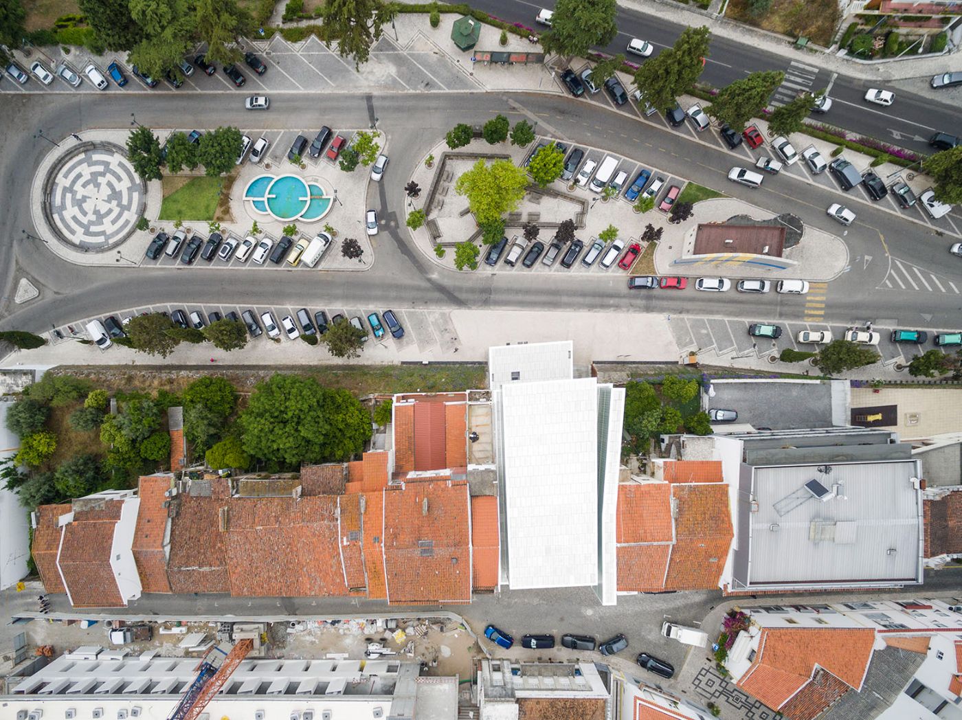 Abrantes Municipal Market by ARX Portugal — Aerial view of Abrantes Municipal Market revealing the urban integration strategy across two streets at different elevations.