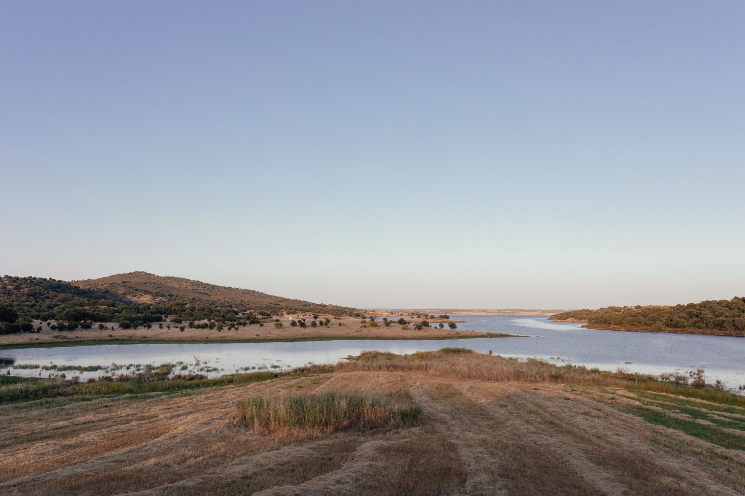 Casa na Terra captured by Thisispaper Studio — Landscape view of the Alentejo region surrounding Casa na Terra, captured from elevated terrain overlooking the architectural intervention.