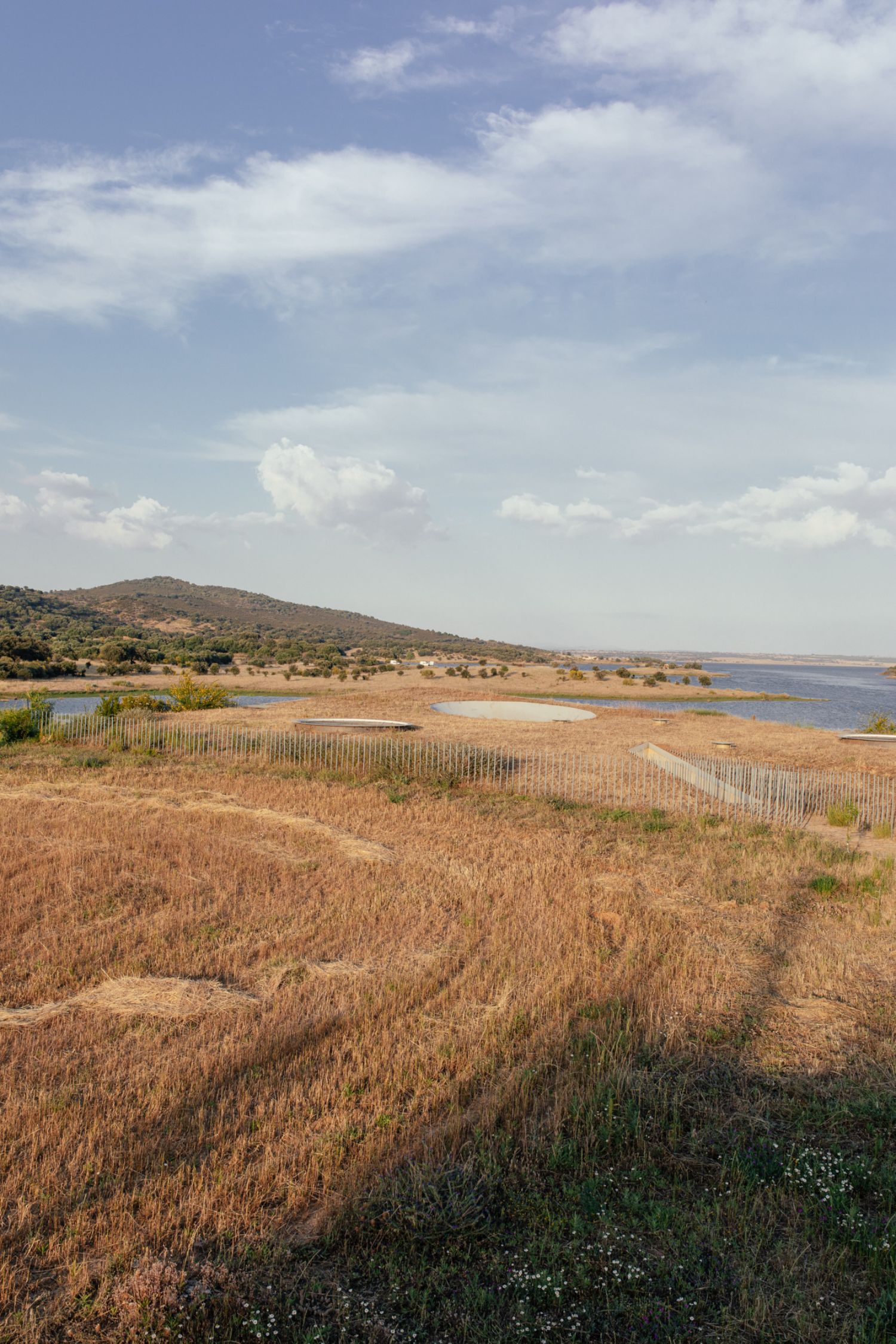 Casa na Terra captured by Thisispaper Studio — Distant view of Casa na Terra revealing its integration into the Alentejo landscape.