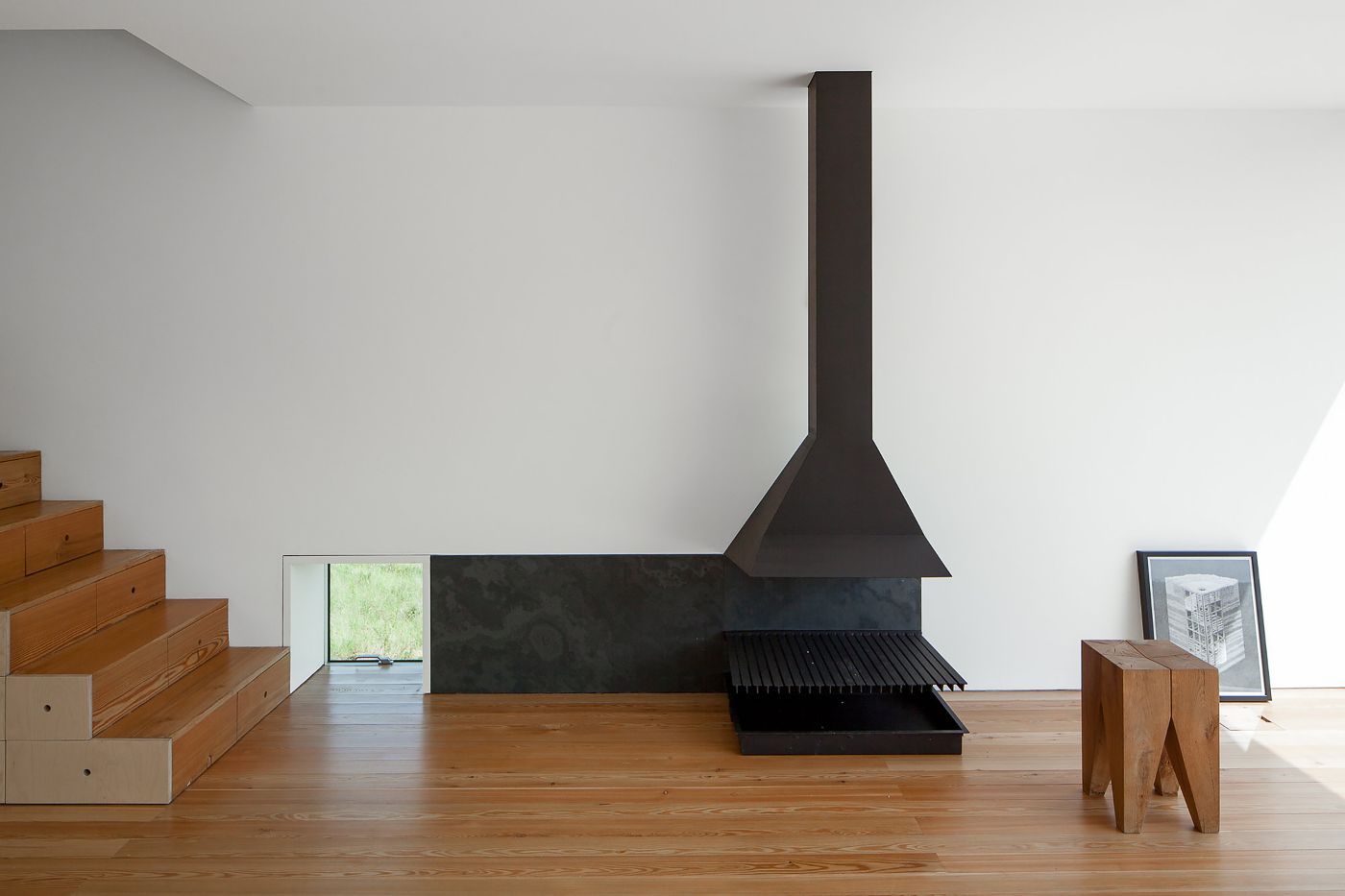 Fonte Boa House by João Mendes Ribeiro — Interior view of Fonte Boa House showcasing the dramatic black steel fireplace as central spatial anchor.