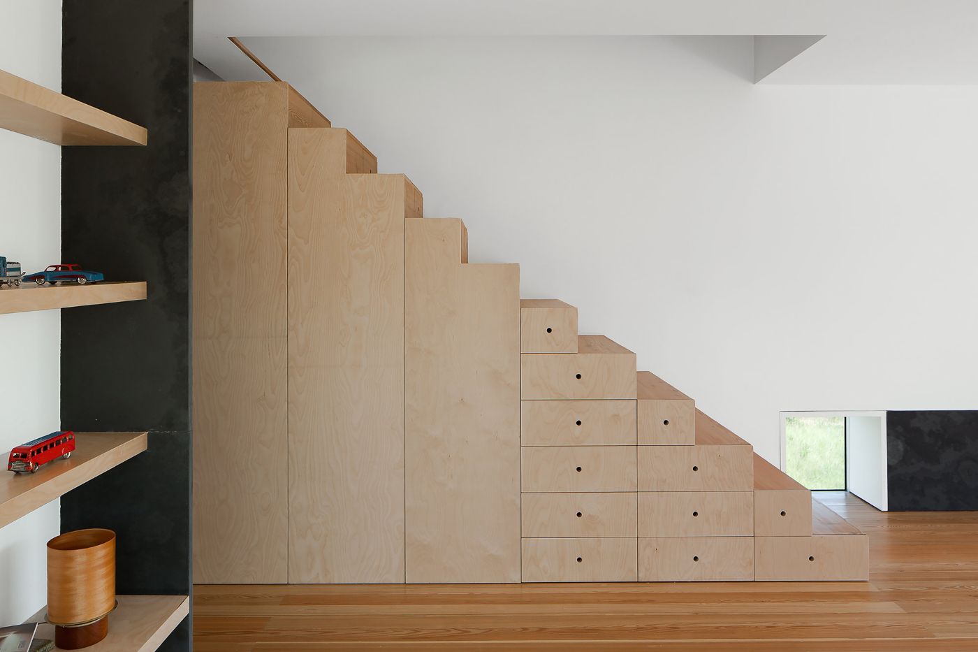 Fonte Boa House by João Mendes Ribeiro — Interior photograph of the Fonte Boa House staircase, revealing the project's modular storage system.
