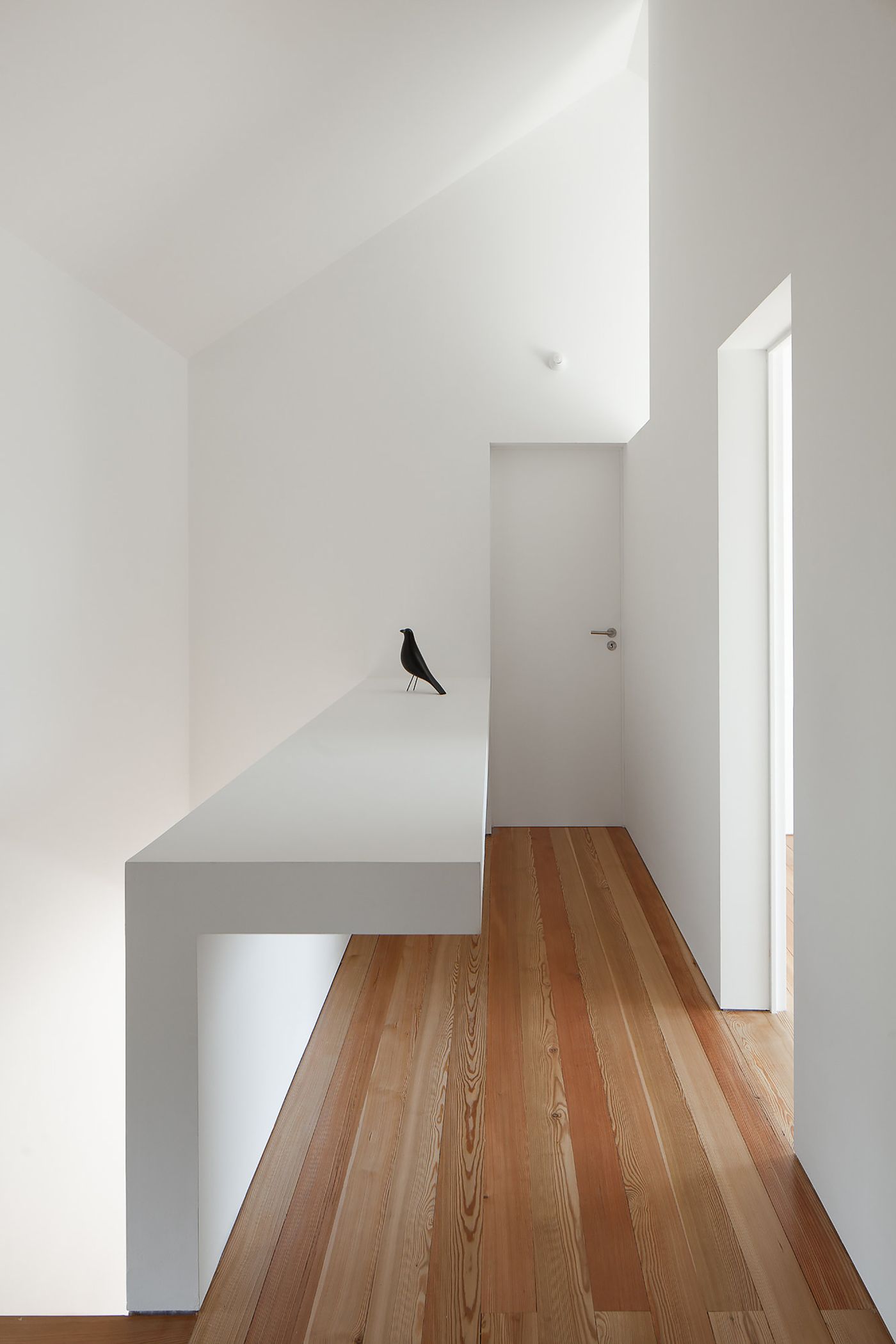 Fonte Boa House by João Mendes Ribeiro — A minimalist corridor interior photographed from the threshold, showcasing the spatial sequence of Fonte Boa House.