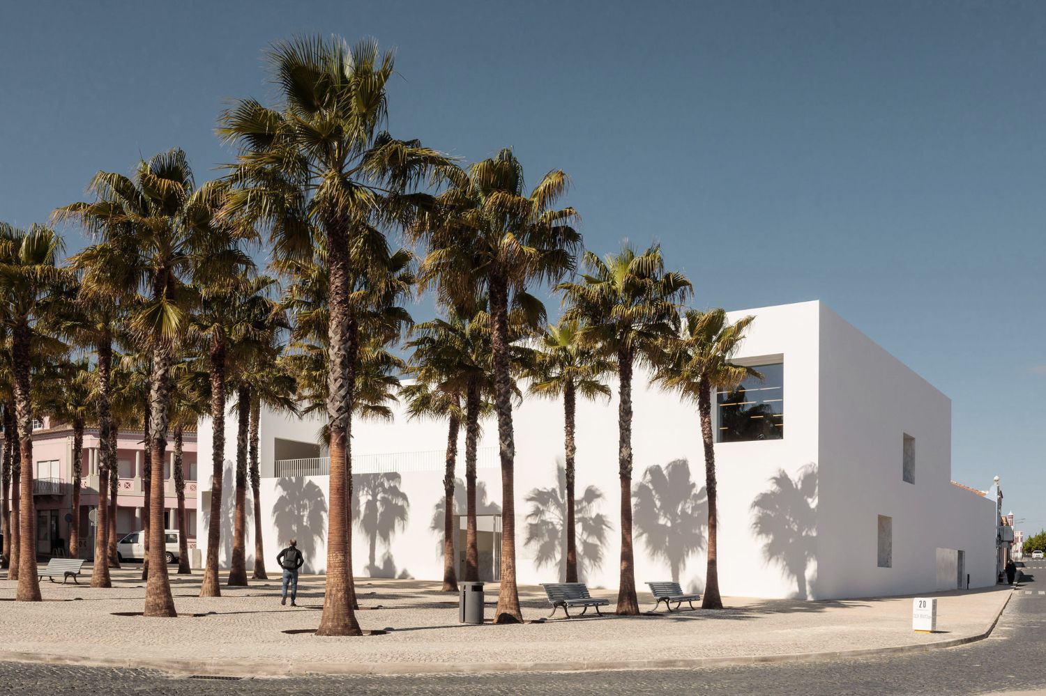 Grândola’s Library and Municipal Archive by Matos Gameiro Arquitectos + Pedro Domingos Arquitectos — The Municipal Library and Archive anchors Grândola's central square with a monolithic white rendered facade.