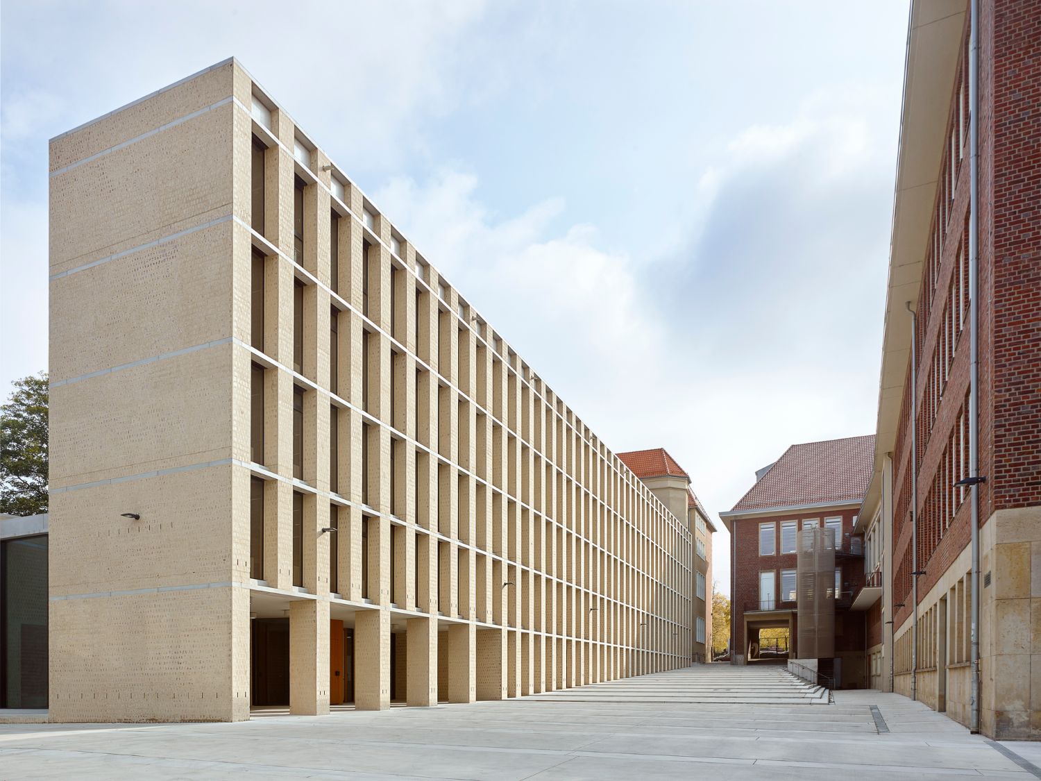Philosophical Seminar at the Cathedral Square by Peter Böhm Architekten — The Philosophikum's atrium courtyard demonstrates a post-and-beam structural system with concrete soffit and steel frame defining the covered passage.