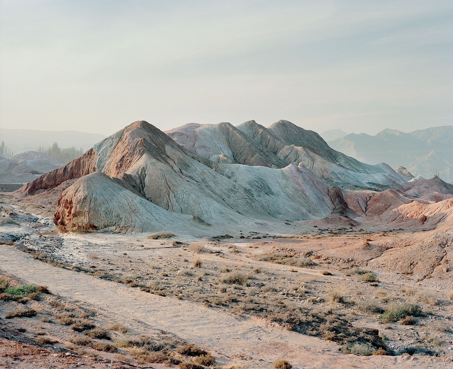 Universal Experience by Catherine Hyland — Hyland documents a mineral-extraction landscape in China transformed into curated terrain.