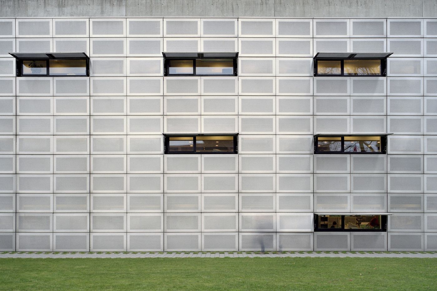 AZL Pension Fund Headquarters by Wiel Arets Architects by WAA Wiel Arets Architects — The AZL Pension Fund Headquarters presents a rigorously modular facade of precast concrete panels arranged in a regular grid, their board-formed surfaces...