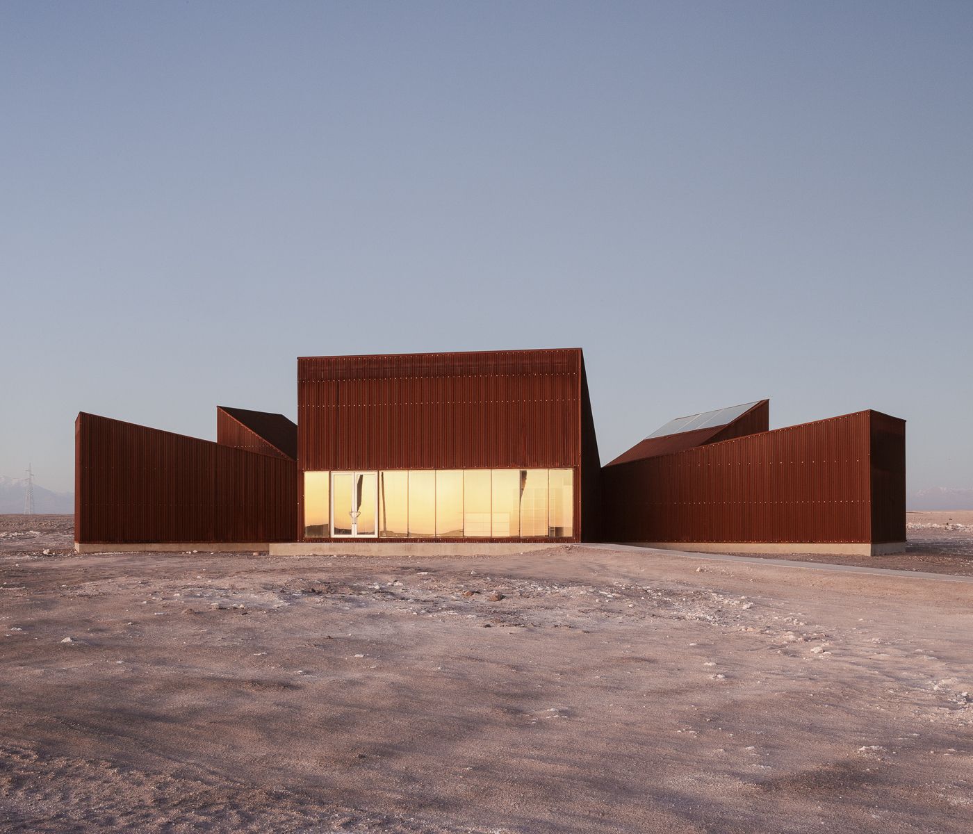 Center of Interpretation of the Desert by Emilio Marín and Juan Carlos López — Three trapezoidal volumes clad in corrugated corten steel occupy an arid desert plain near Calama, Chile.