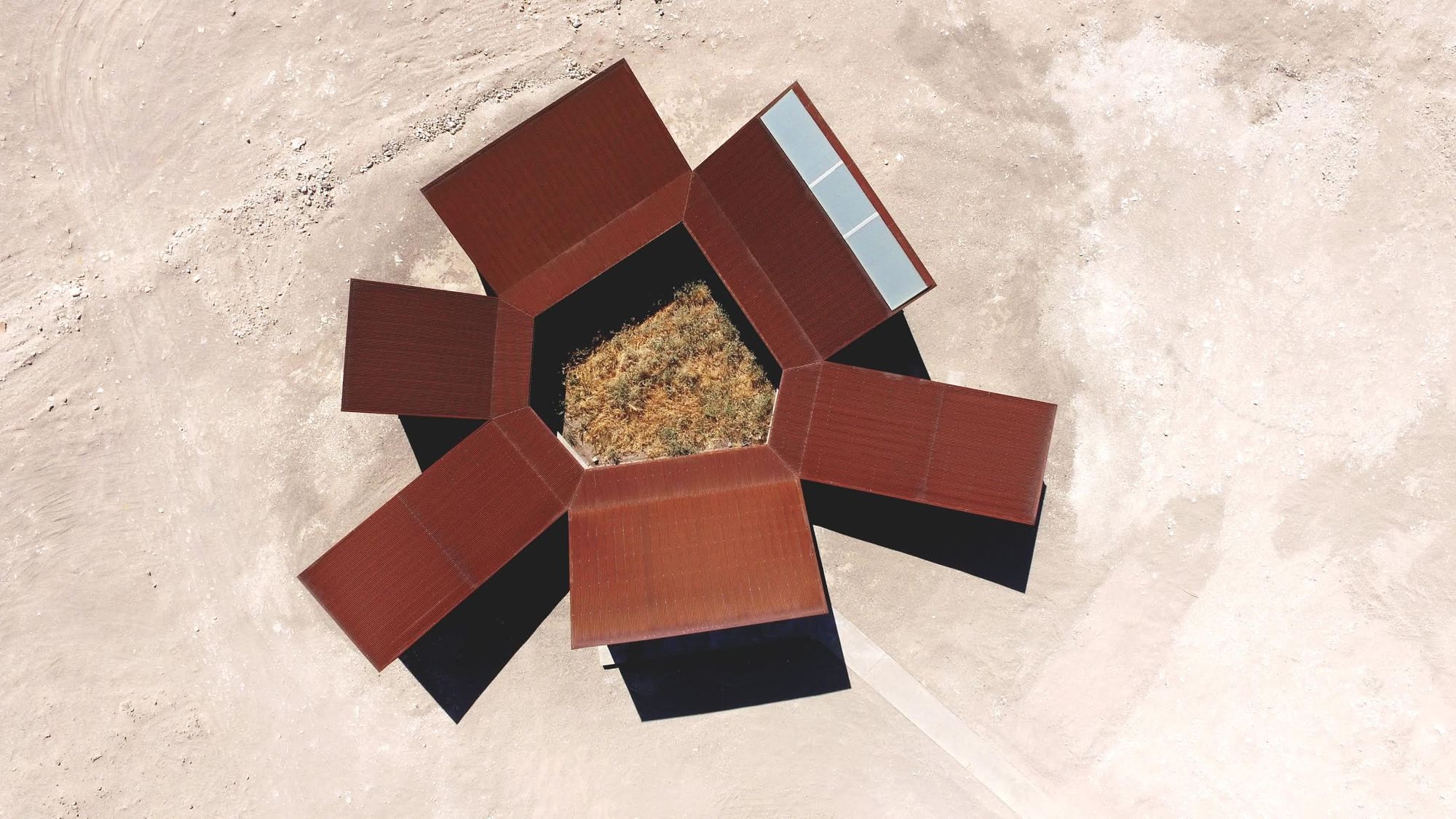 Center of Interpretation of the Desert by Emilio Marín and Juan Carlos López — Overhead view of the Center of Interpretation's corrugated corten steel construction, revealing the assembly logic of three trapezoidal volumes arranged...