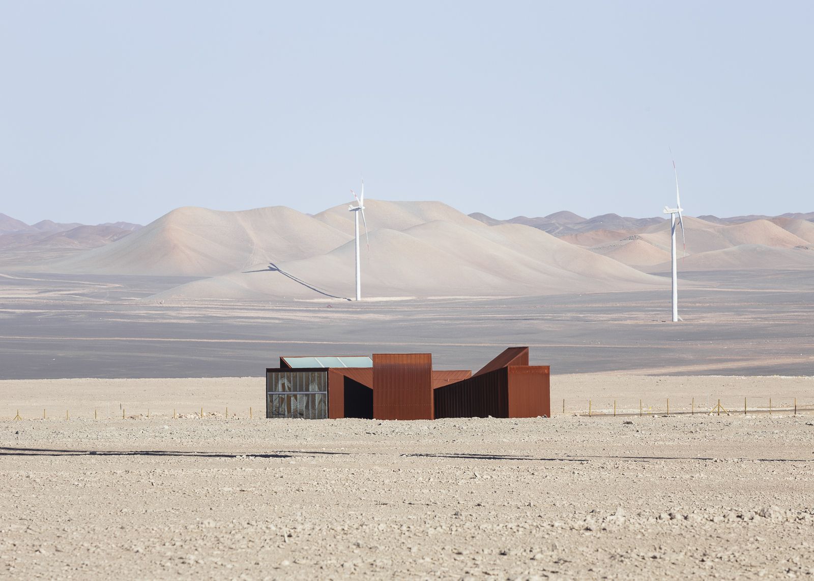 Center of Interpretation of the Desert by Emilio Marín and Juan Carlos López — Three trapezoidal volumes clad in corrugated corten steel occupy the Atacama Desert floor, their asymmetric arrangement anchored by angled roof planes that...