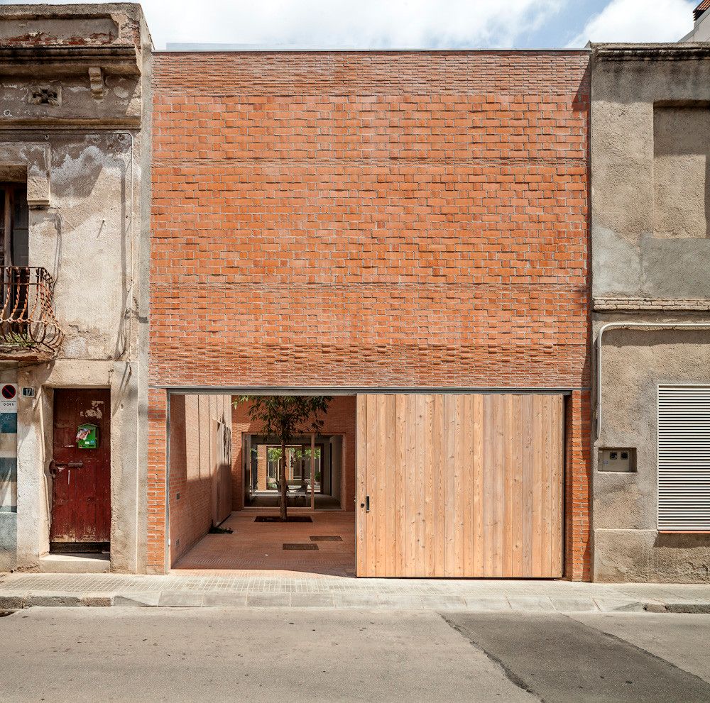 House 1014 by H Arquitectes — House 1014 presents a compressed urban frontage where a six-meter-wide plot required strategic material and spatial articulation.