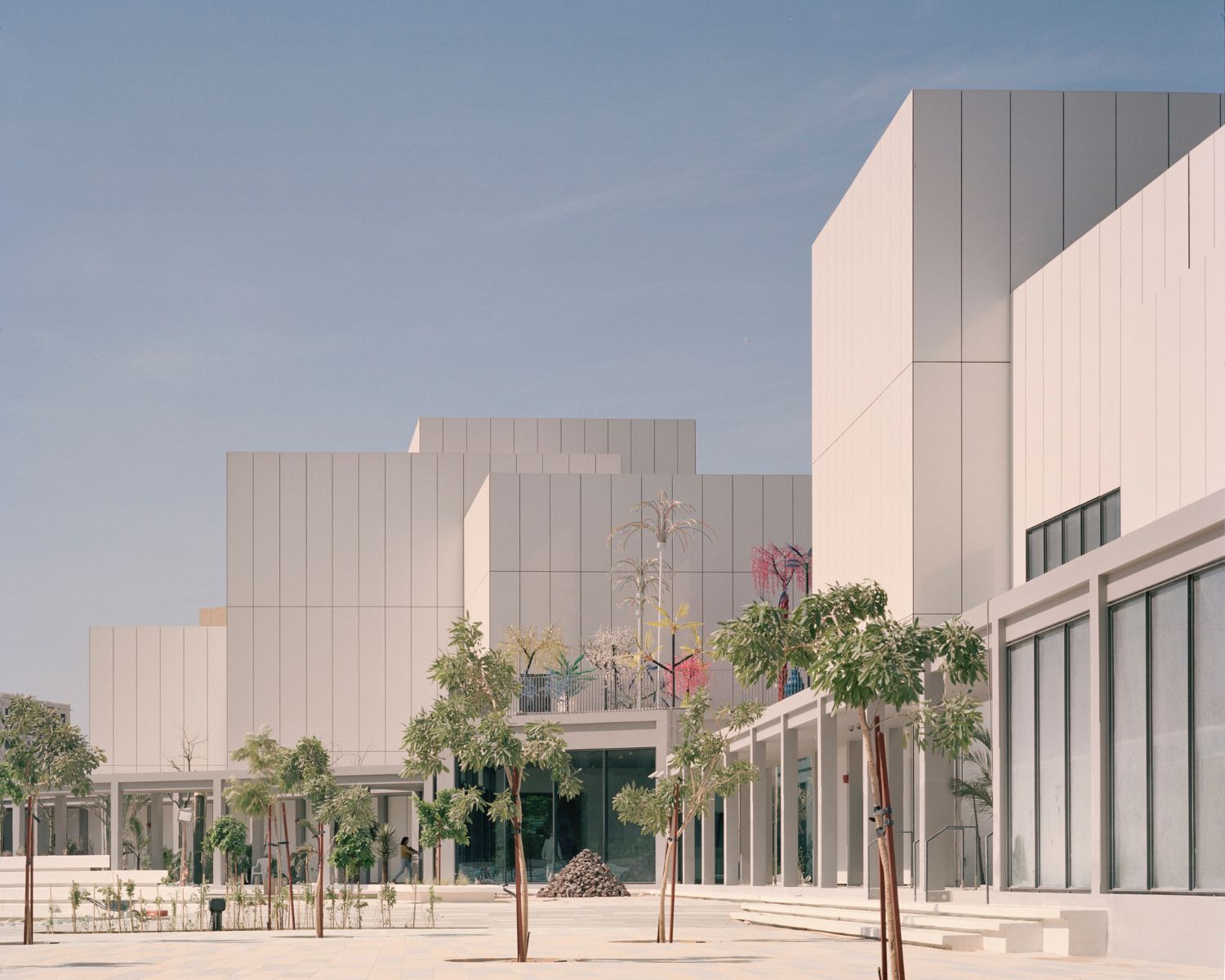 Jameel Arts Centre Dubai by Serie Architects — The Jameel Arts Centre's courtyard facade demonstrates Serie Architects' systematic material language through corrugated white aluminum cladding with...