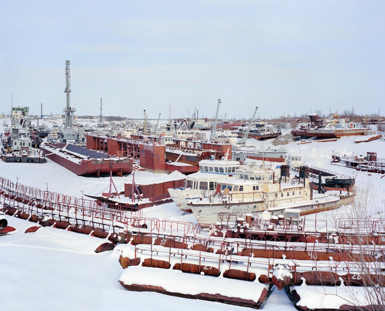 Sacha by Alexis Pazoumian — A frozen industrial harbor in Yakutia captures the infrastructure of Russia's Arctic shipping operations during winter.