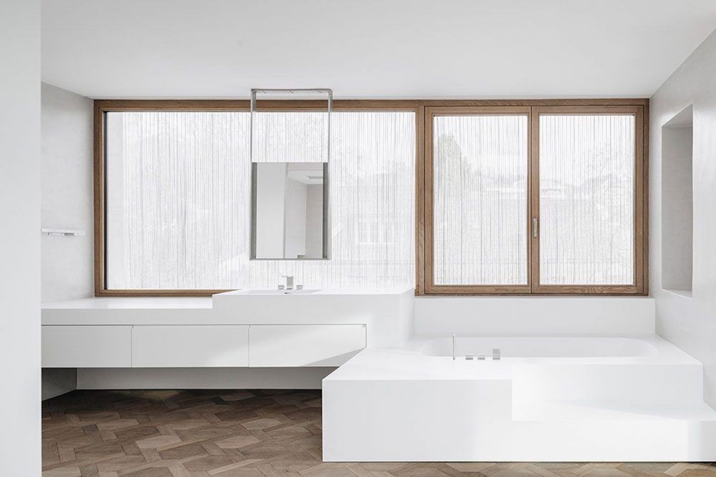 House for an Art Collector by Think Architecture — A bathroom interior featuring a minimalist palette of white fixtures and surfaces.