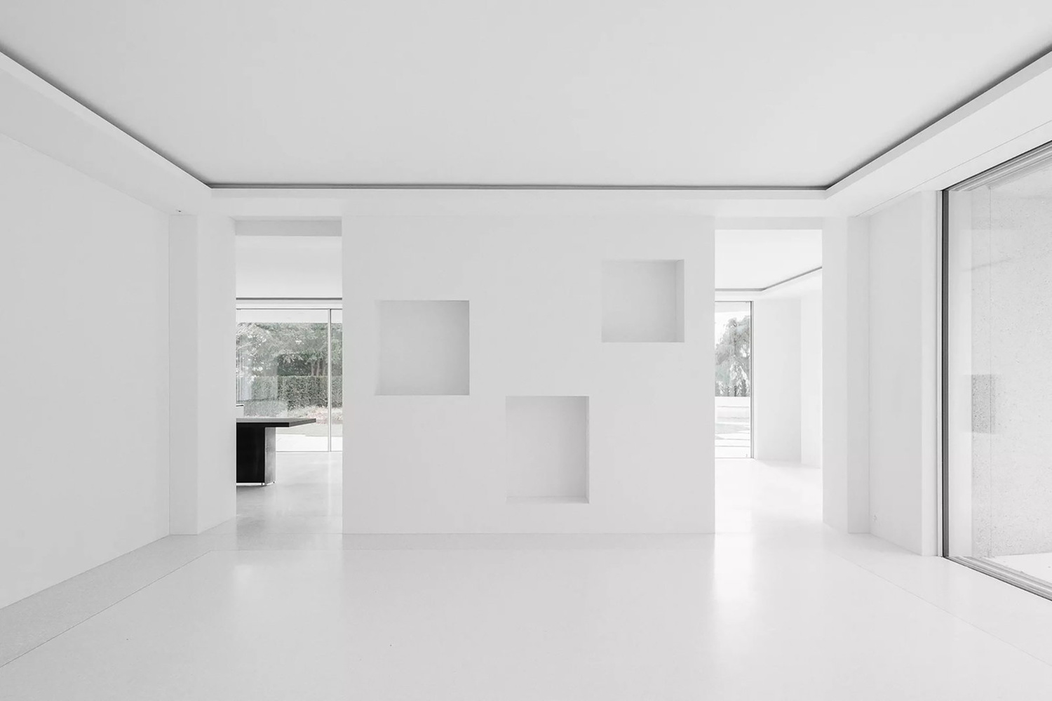House for an Art Collector by Think Architecture — Empty gallery space with polished concrete flooring reflecting overhead light.