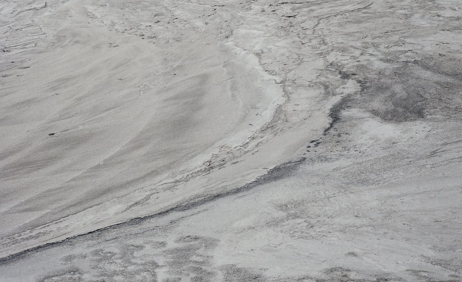 Along the Swift Current of Time by Teodora Georgieva — Aerial view of industrial chemical deposits in Devnya, Bulgaria, revealing stratified mineral accumulation across a barren landscape.