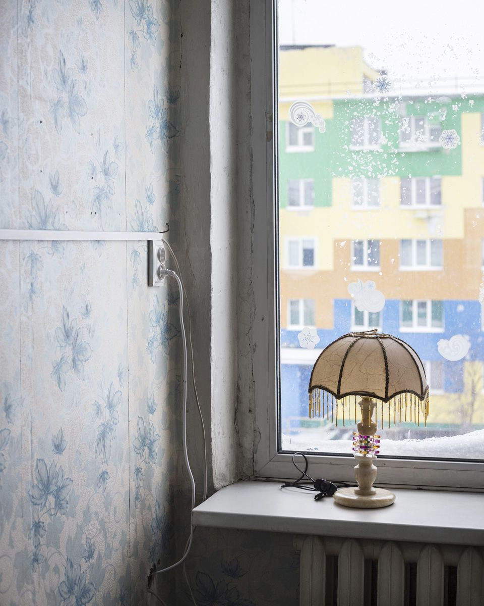 Удачный / Lucky by Hanne Van Assche — A window ledge in Udachny frames a domestic moment against the Yakutian winter.