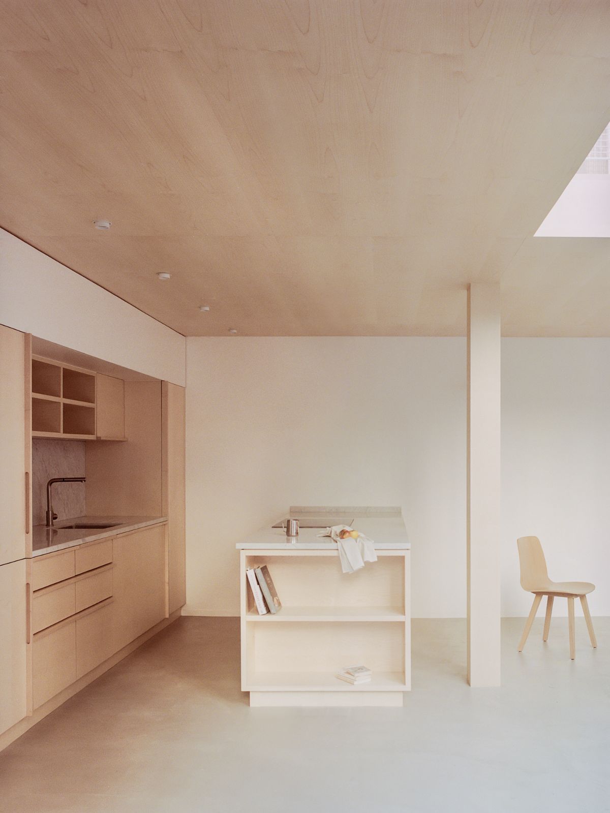 Jean Moulin Atelier – House by Atelier NEA — The renovated artist studio demonstrates spatial organization through a tripartite arrangement: custom light oak cabinetry with flush joinery occupies the...