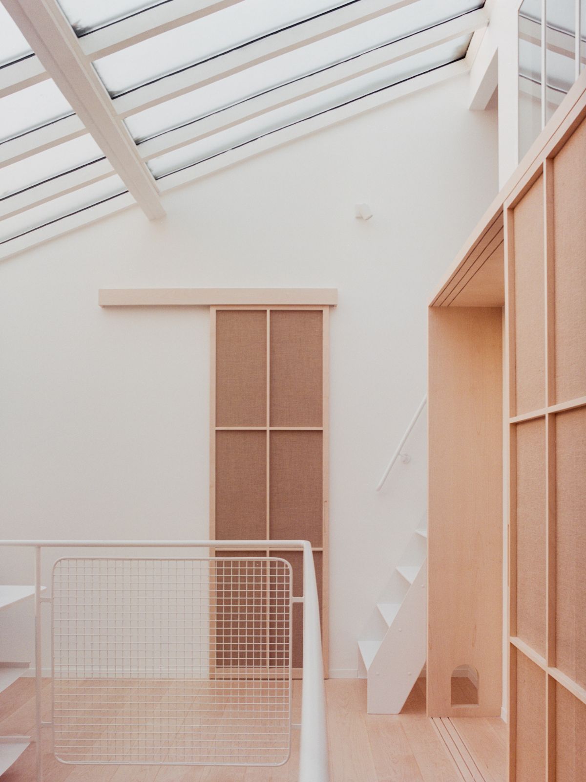 Jean Moulin Atelier – House by Atelier NEA — A south-facing interior of the Jean Moulin Atelier reveals a deliberately restrained spatial arrangement.