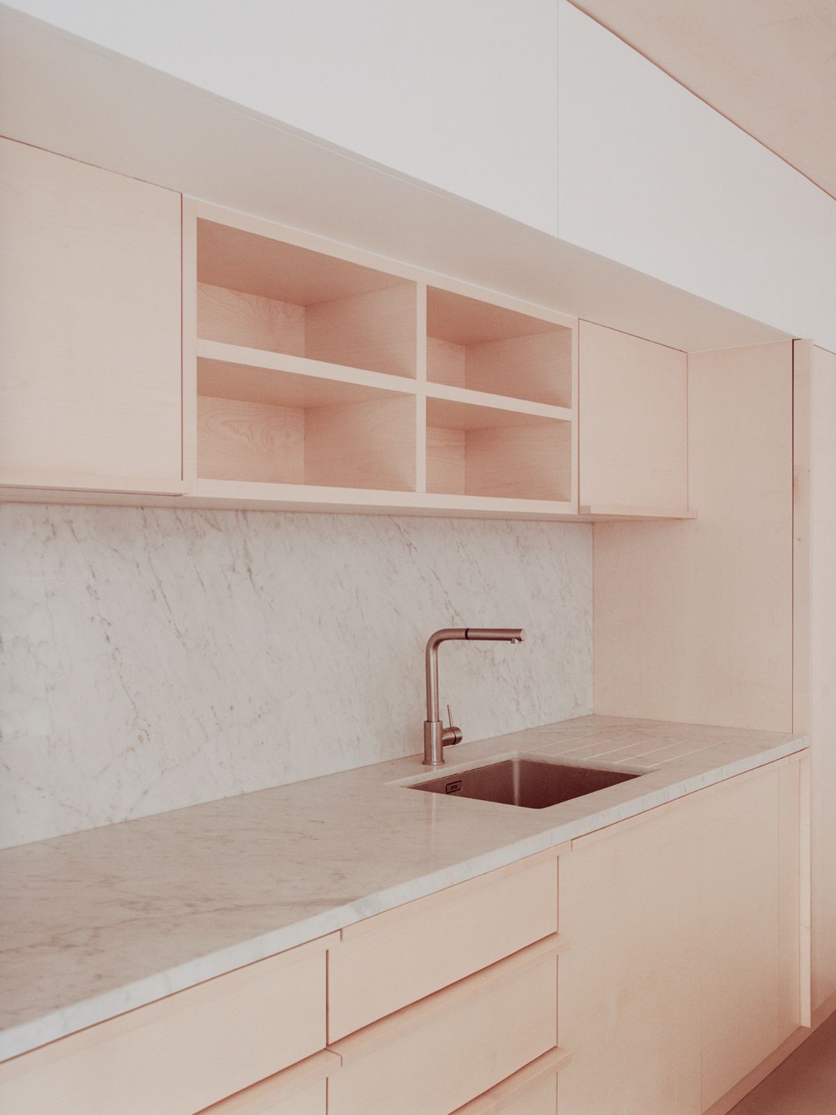 Jean Moulin Atelier – House by Atelier NEA — Kitchen workspace within the Jean Moulin Atelier featuring a continuous light oak cabinetry system with flush joinery details.