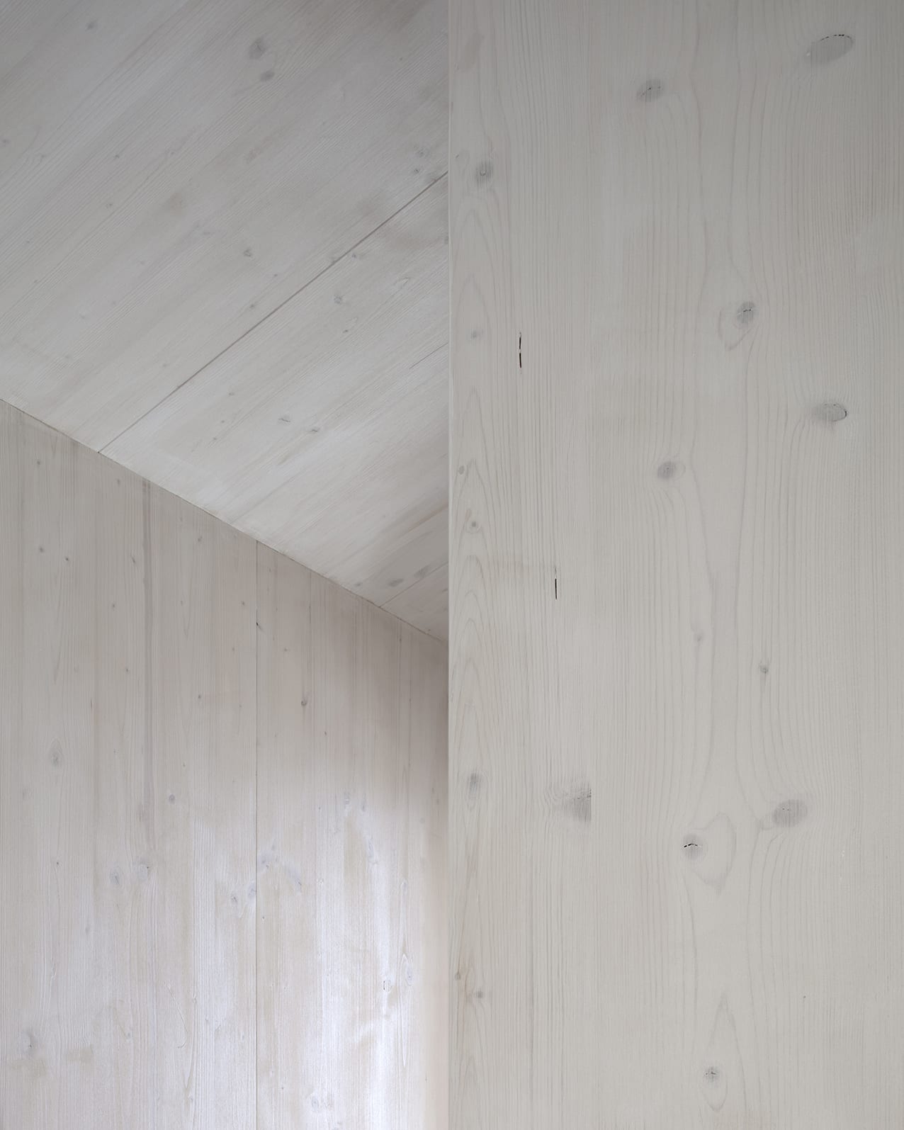 En Chalméry House by Christian Dupraz Architects — Interior corner detail of En Chalméry House revealing the material palette and construction approach.