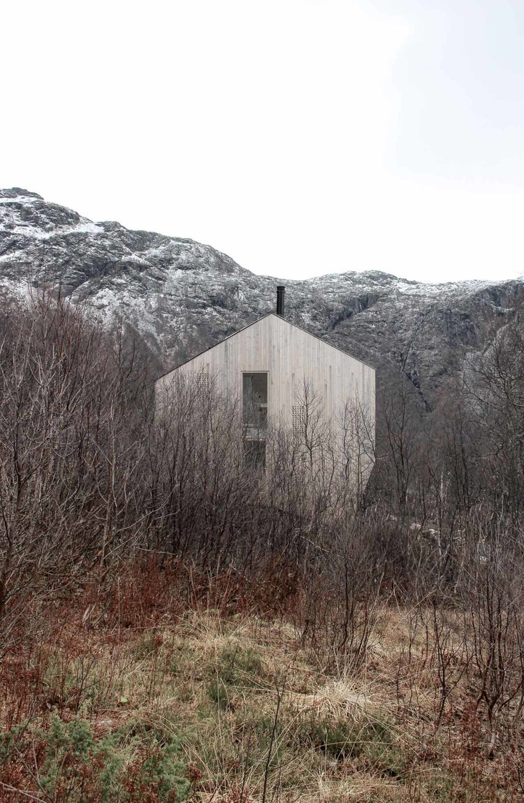 Røldal Cabin by Reiulf Ramstad Arkitekter — The Røldal Cabin emerges from a dense thicket of bare deciduous trees and low vegetation, its geometric form a counterpoint to the organic landscape.