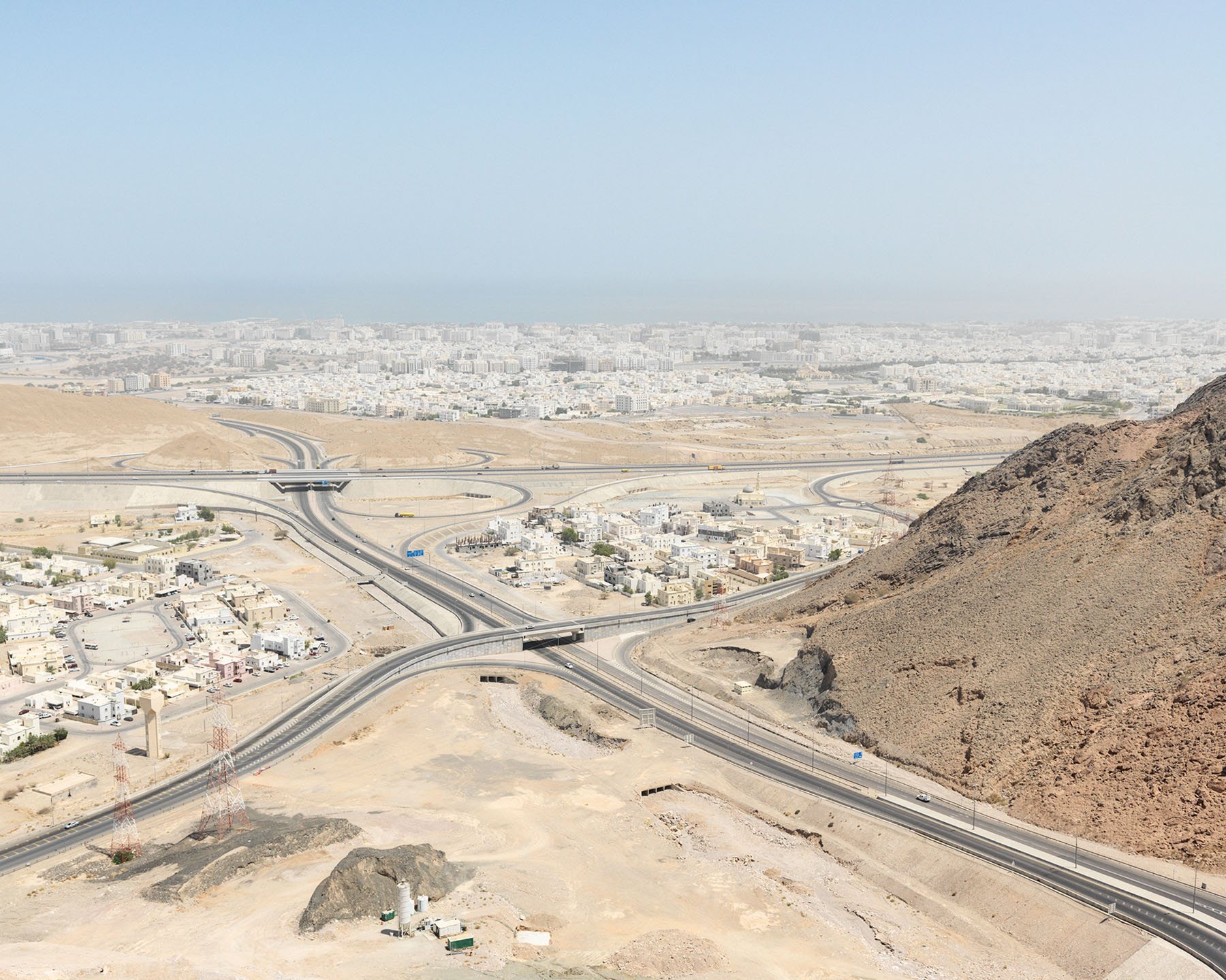 LIKE by Ryan Debolski — Aerial photograph of a major highway interchange cutting through desert terrain near Muscat, Oman.