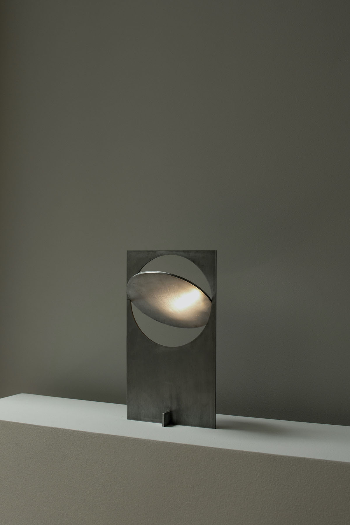 OBJ-01 by Manu Bañó — OBJ-01 mounting detail showing the rotating circular metal screen element bisected by a horizontal slot.