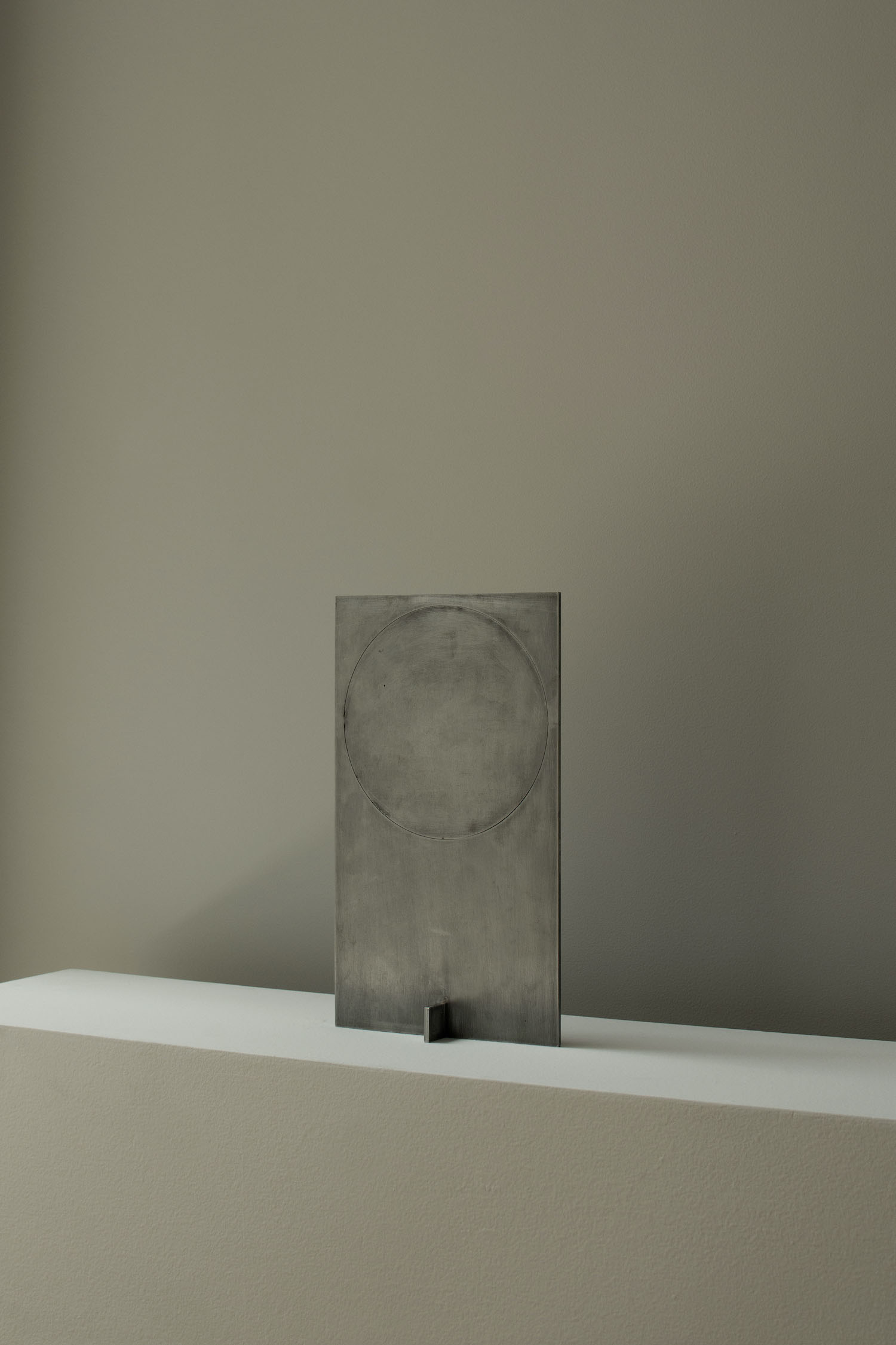 OBJ-01 by Manu Bañó — OBJ-01 presents a laser-cut metal panel with a rotatable circular screen element.