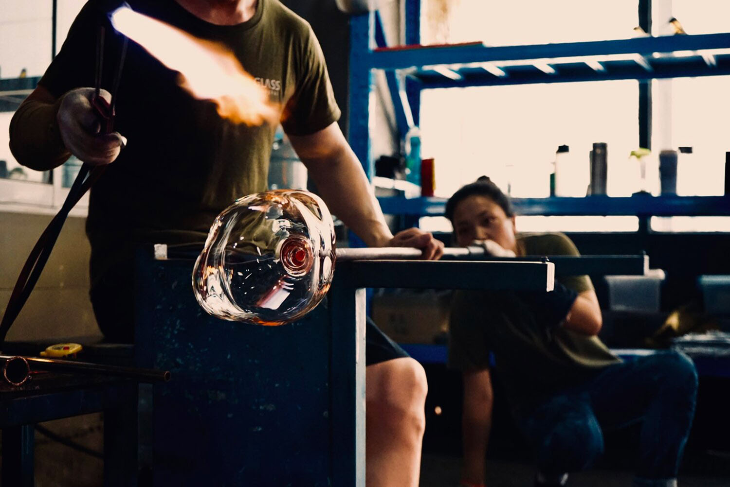 Bubble by Yuhsien Design Studio — A glassblower demonstrates the Bubble vessel's double-walled construction, holding the piece aloft to reveal its asymmetrical outer envelope and inner...