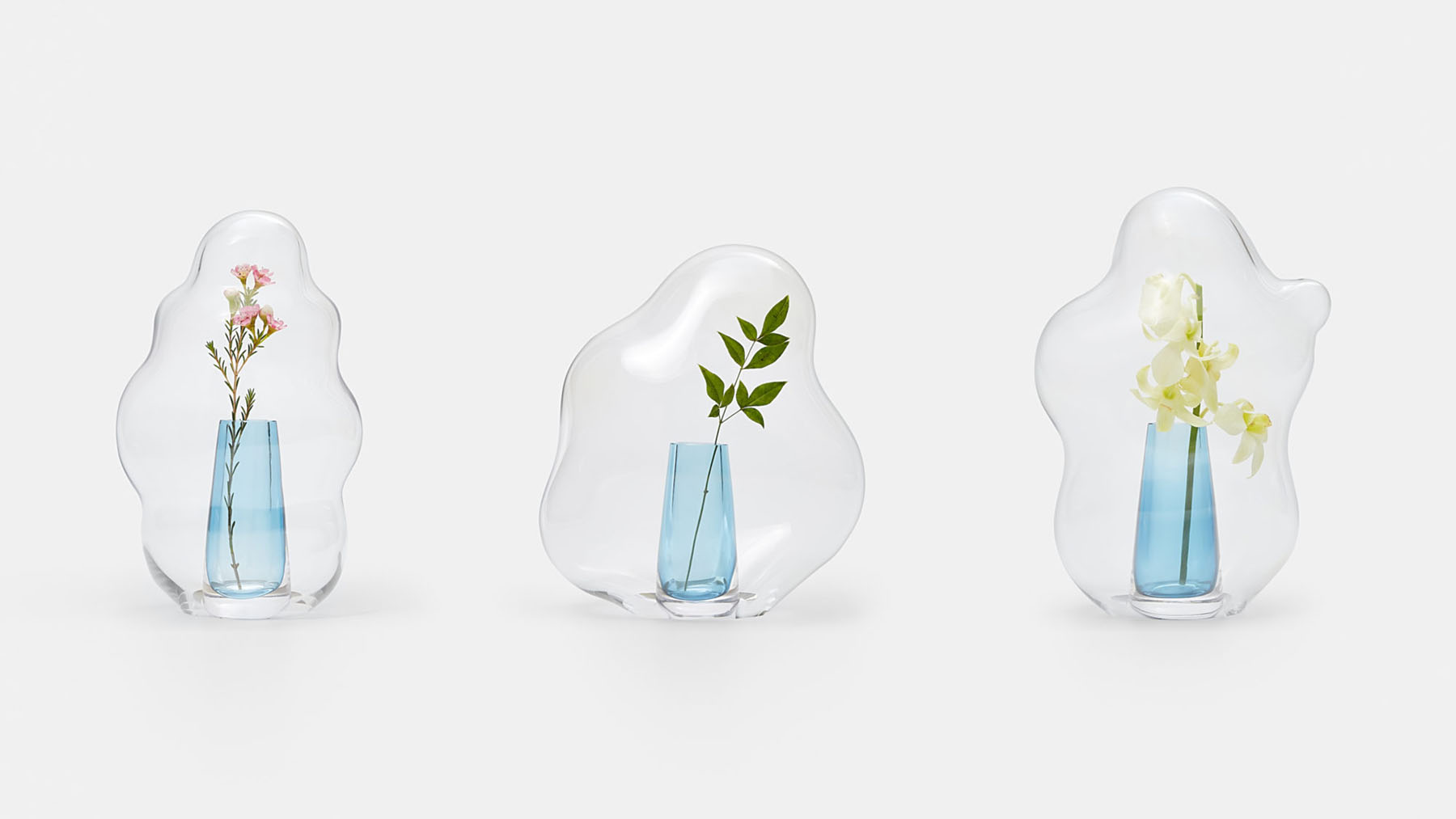 Bubble by Yuhsien Design Studio — Bubble vases by Yuhsien Design Studio present three variations of double-walled glass vessels, each containing fresh botanical specimens.