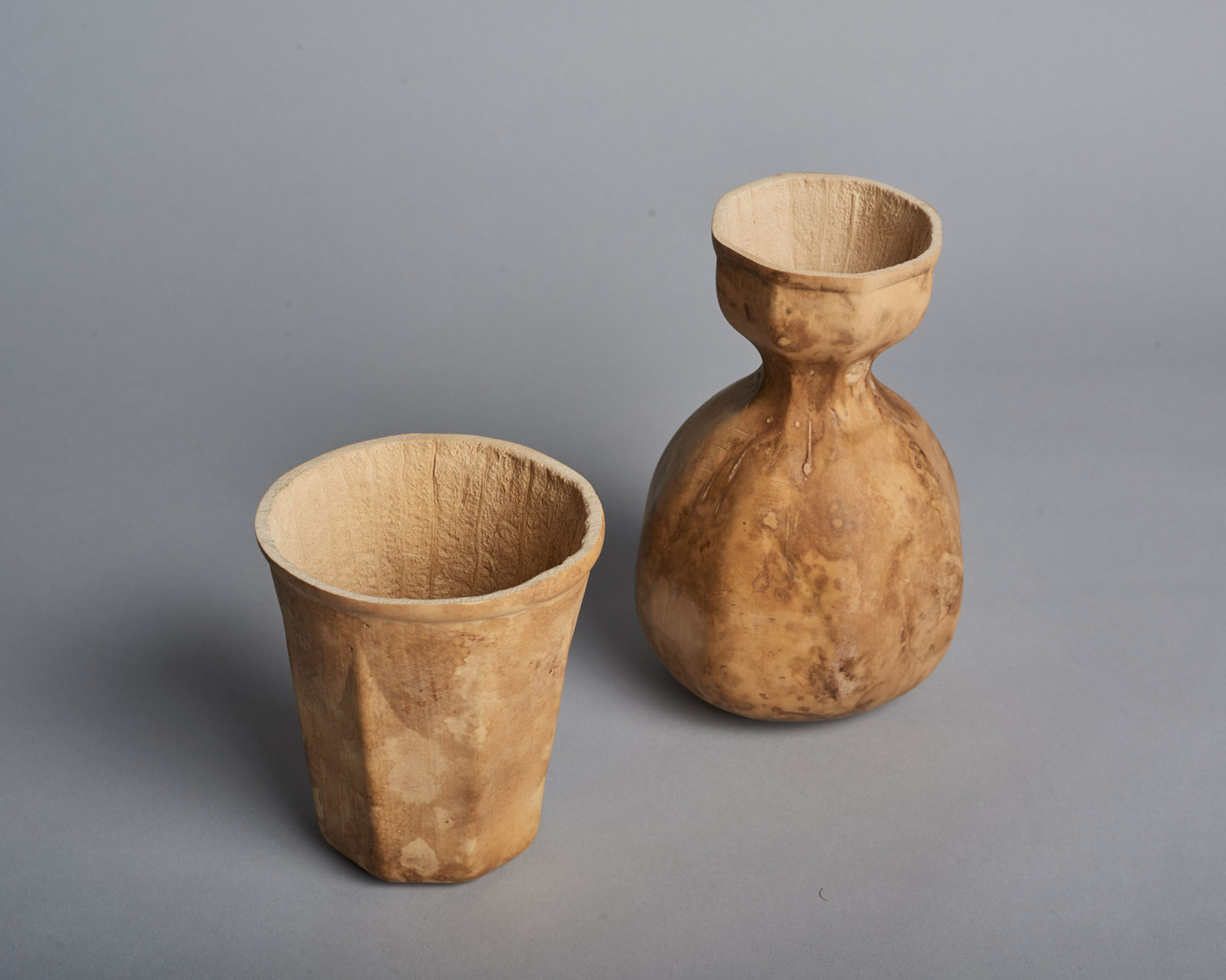 Biodegradable HyO-Cup by Crème — Two biodegradable gourd vessels photographed against a neutral grey ground.