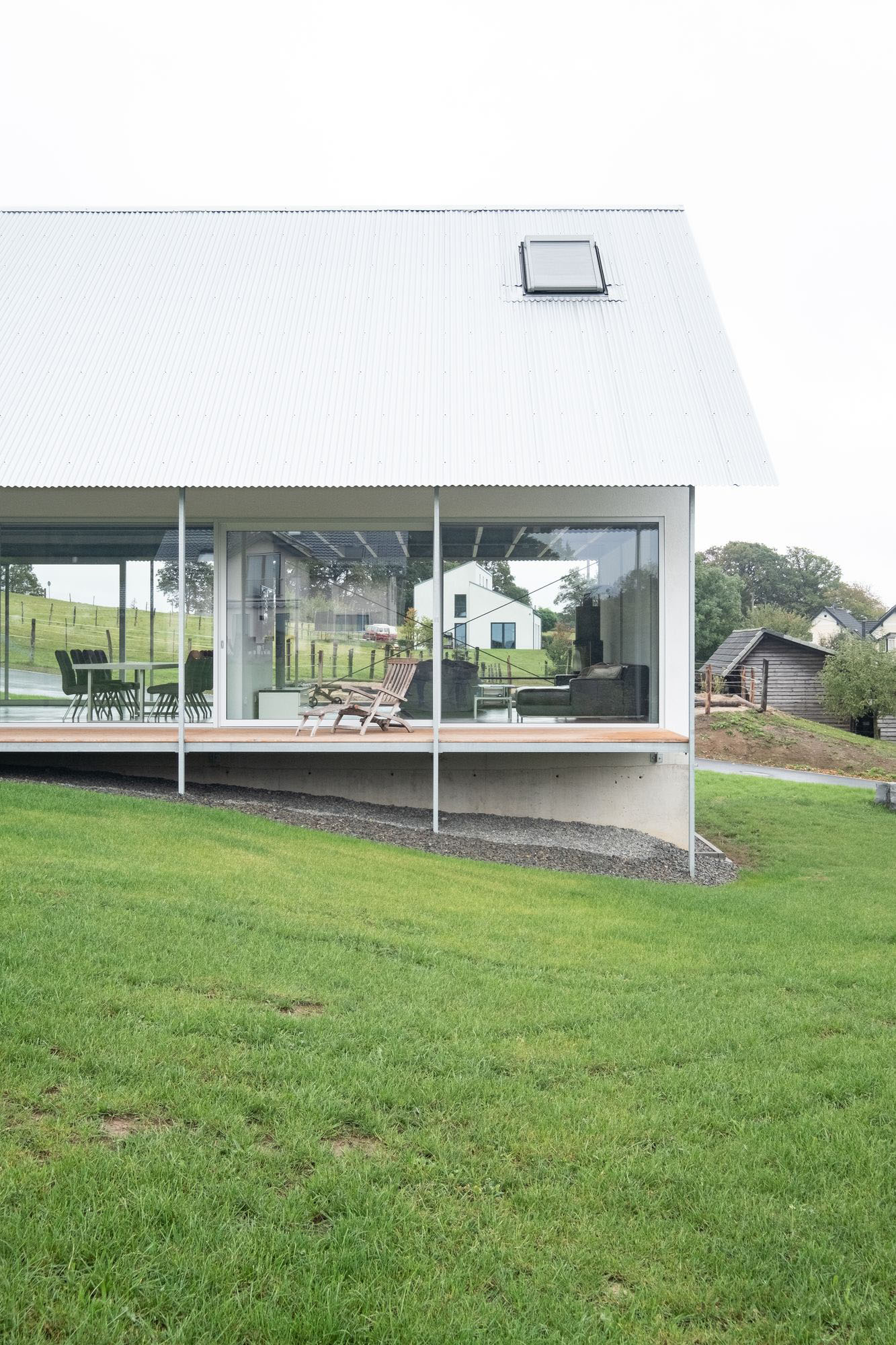 House D6 by Aretz Dürr Architektur — House D6's south-facing facade demonstrates the design's core strategy: a floor-to-ceiling glazed threshold that dissolves the boundary between interior and...