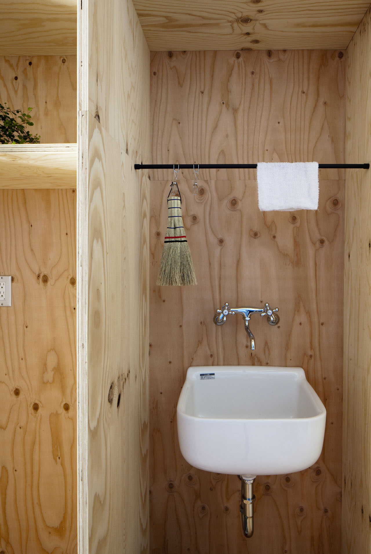Ant-house by mA-style Architects — A utilitarian bathroom interior clad entirely in light plywood with visible knots and grain patterns.