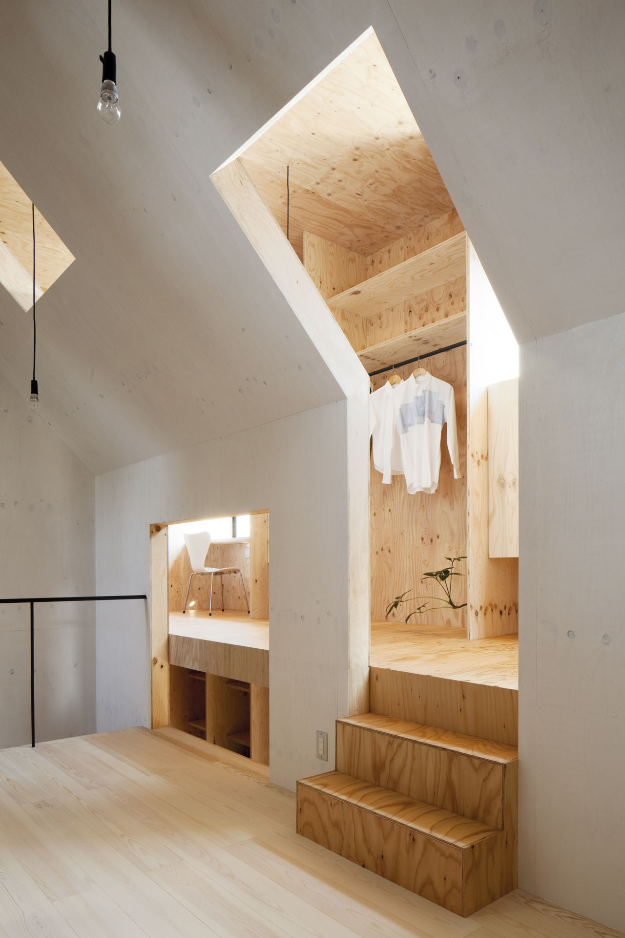 Ant-house by mA-style Architects — A timber-lined interior volume rises through the center of Ant-house, framed by white plywood walls and accessed via wooden steps.