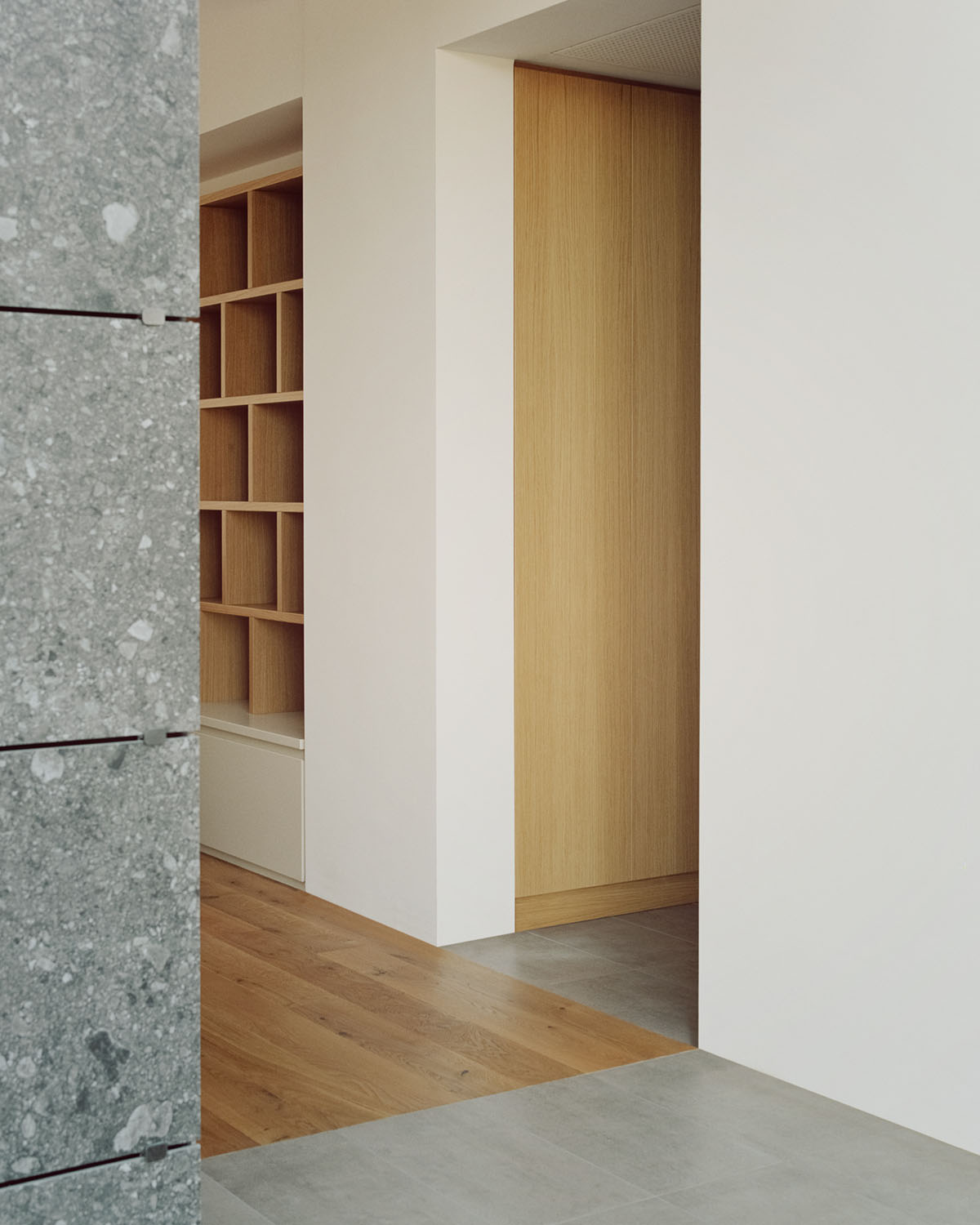 Casa Quattro by LCA Architetti — Interior passage framing a view into Casa Quattro's primary living space.