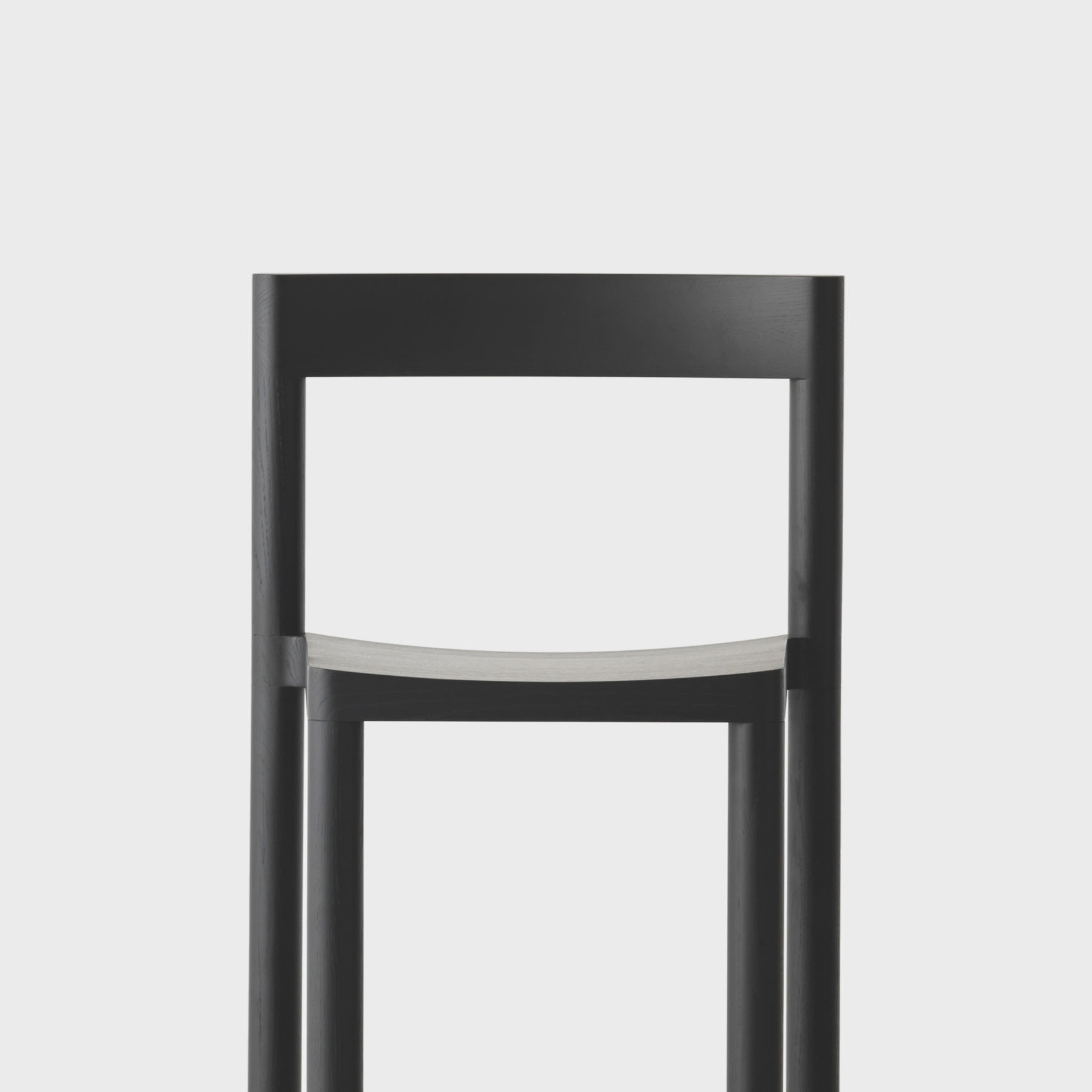 Pier Chair by Leonard Kadid — Front elevation of the Pier Chair reveals its structural logic through dark-stained oak framing.
