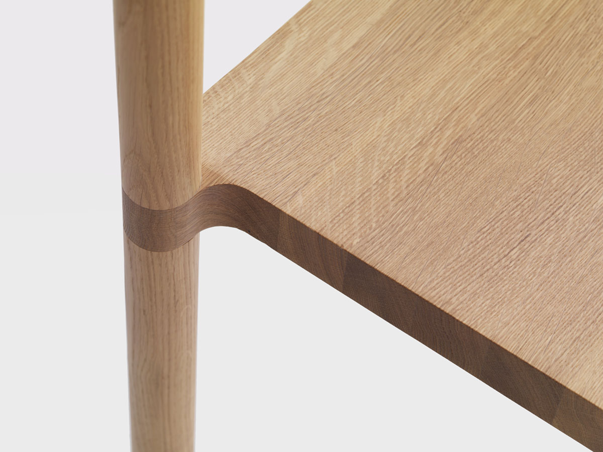 Pier Chair by Leonard Kadid — Close-up detail of the Pier Chair's mortise and tenon joinery, where a light oak vertical post intersects with a darker-stained horizontal rail.