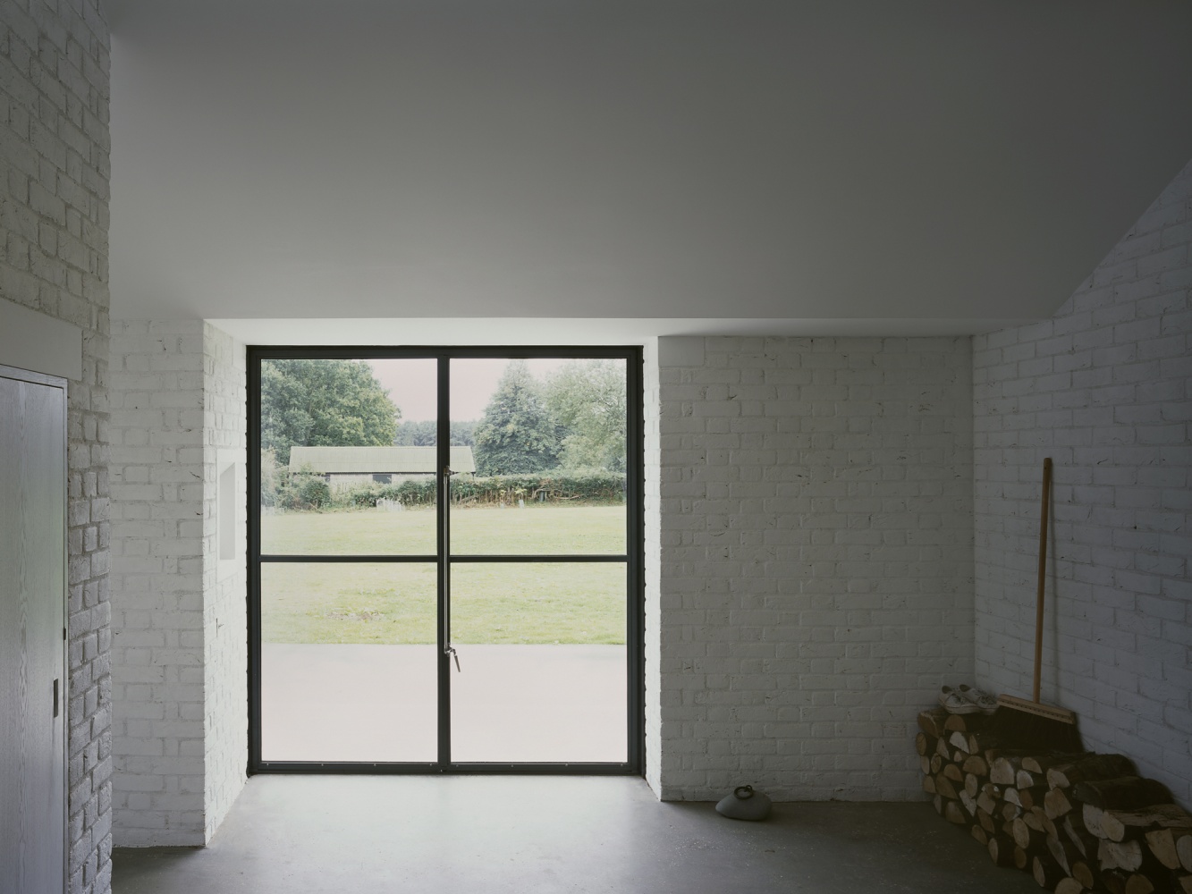 Stable Acre House by David Kohn — A double-glazed threshold frames the transition from interior to landscape.