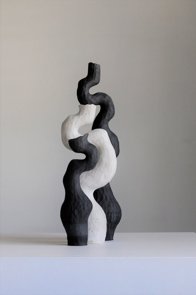 Ceramics by Kerryn Levy — A hand-thrown ceramic sculpture stacked vertically with alternating black and white clay sections, creating a rhythmic striped pattern.